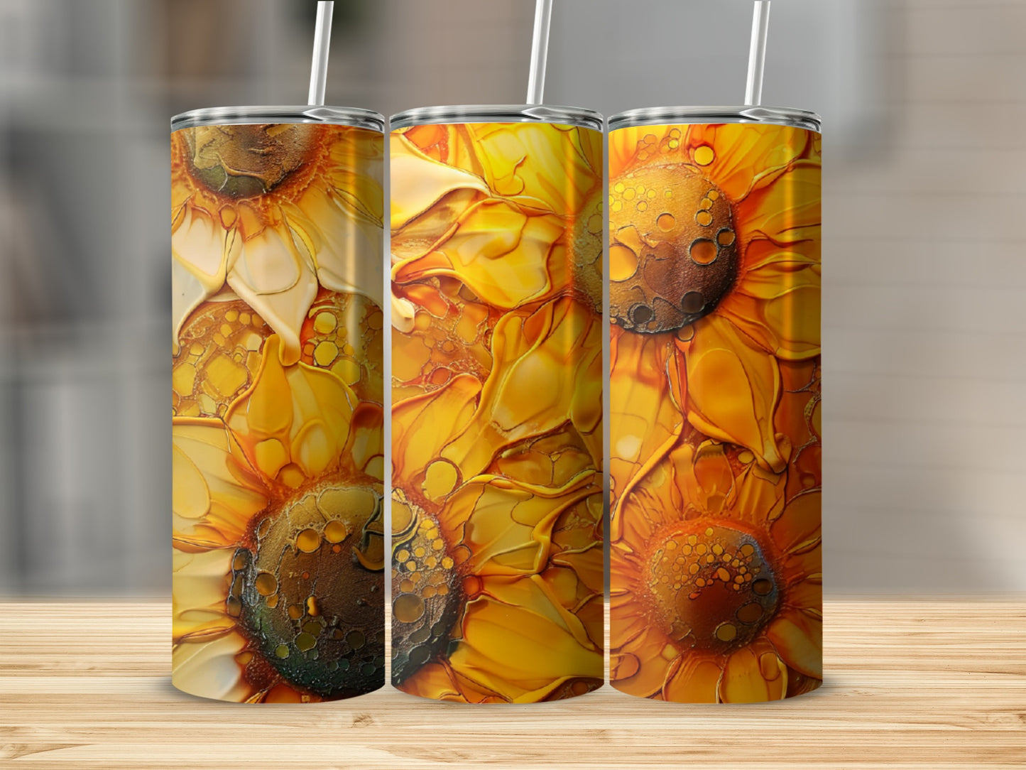 Three tumblers with abstract sunflower art on a wooden surface.