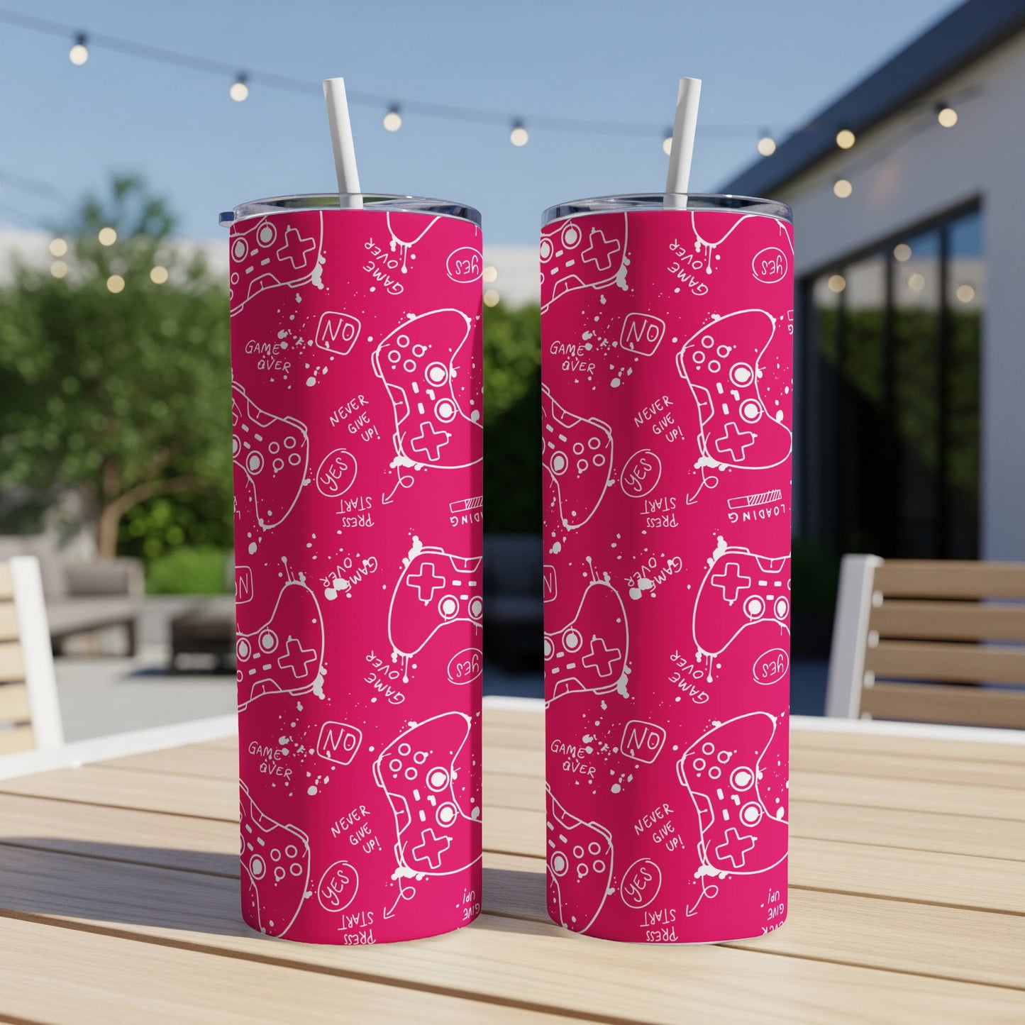 Two pink tumblers with white video game controller pattern and text.