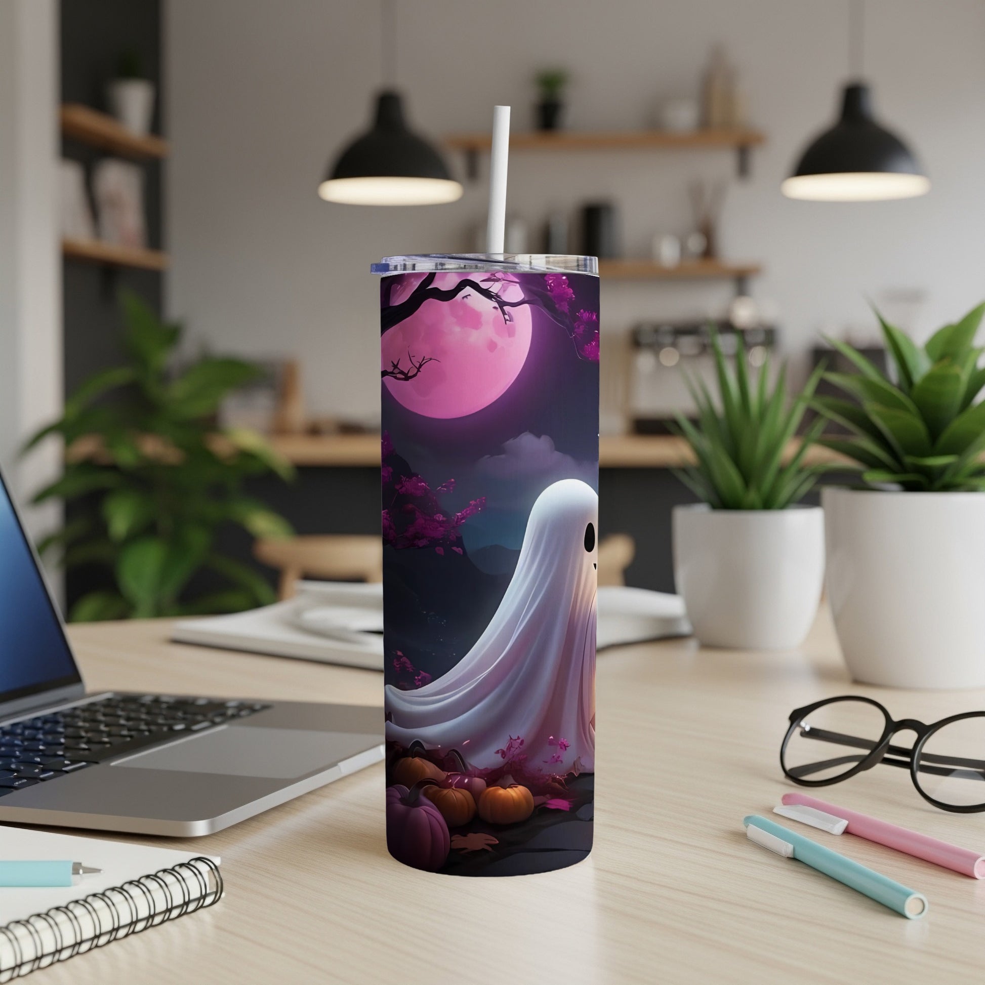 Tumbler with a white ghost and pumpkins under a pink moon and purple trees.