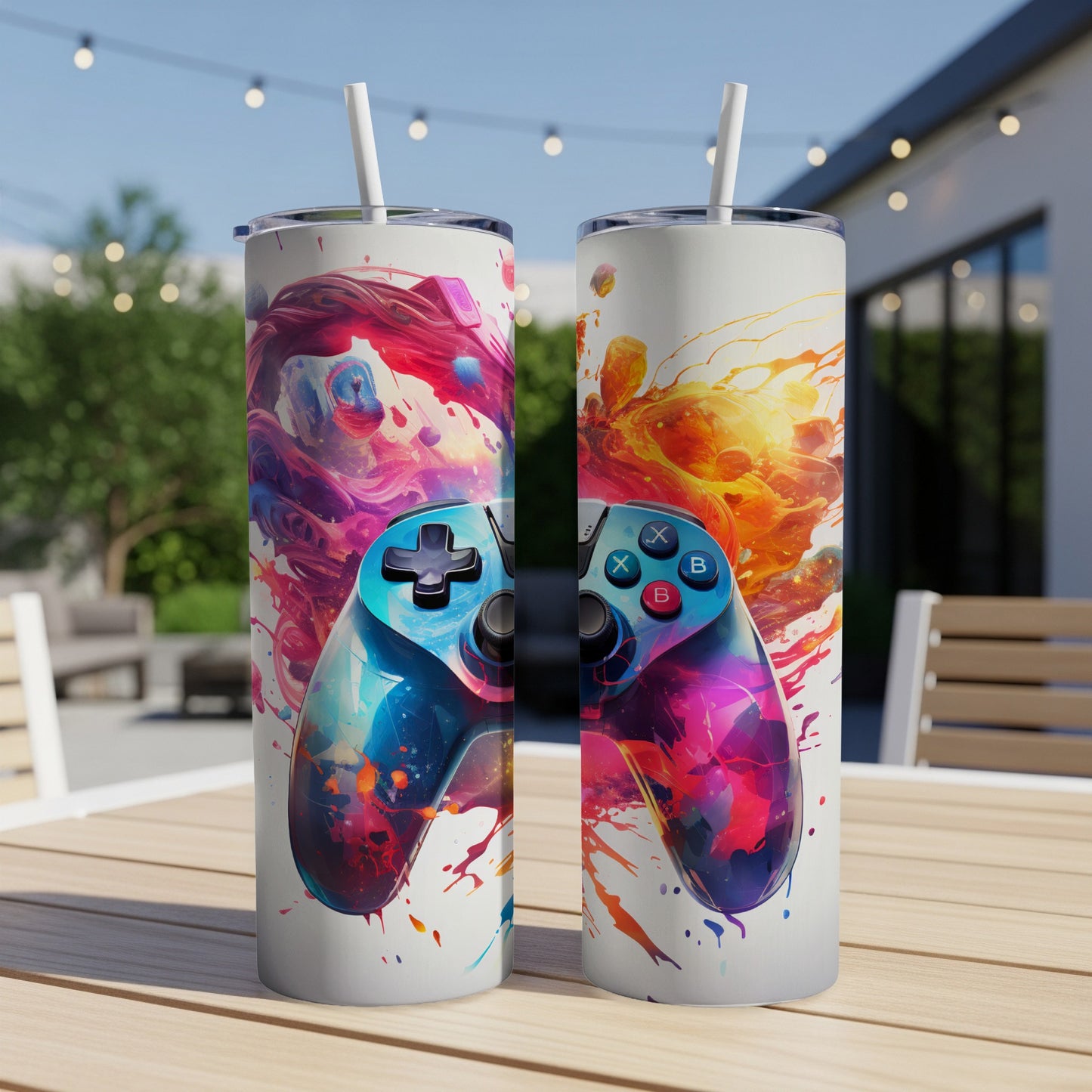 Two tumblers with a colorful video game controller design on a wooden table.