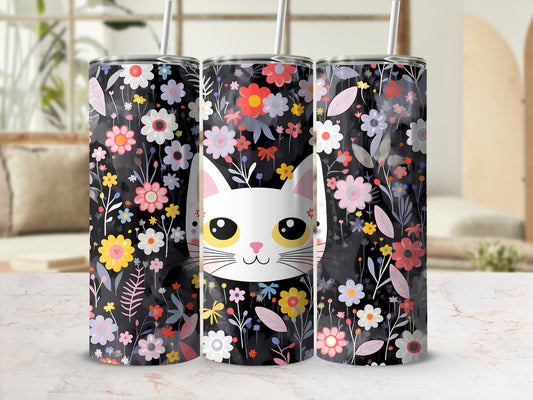 Black tumbler with cute cat face and colorful floral pattern.
