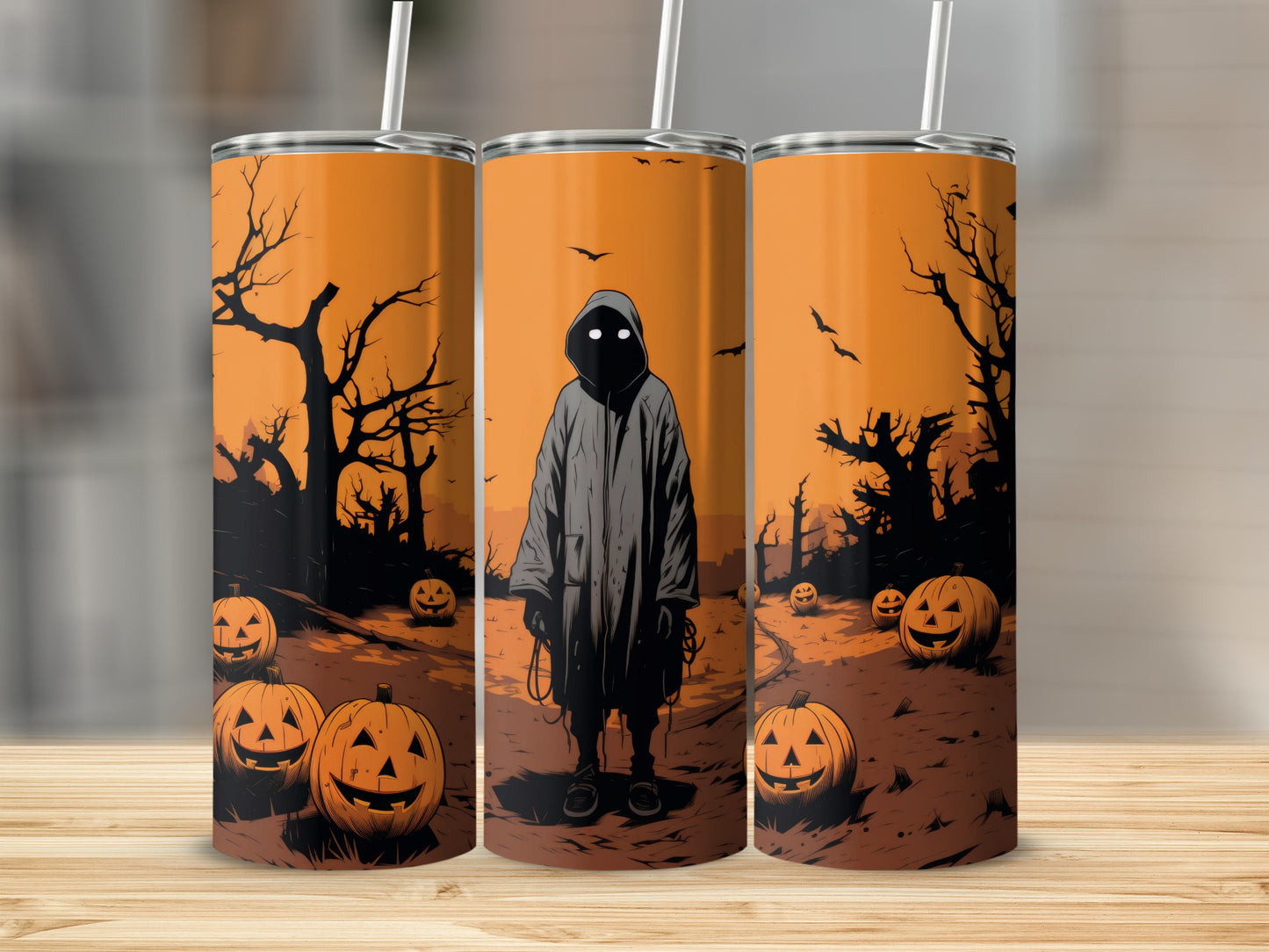 Three tumblers featuring a Halloween scene with a hooded figure and pumpkins.