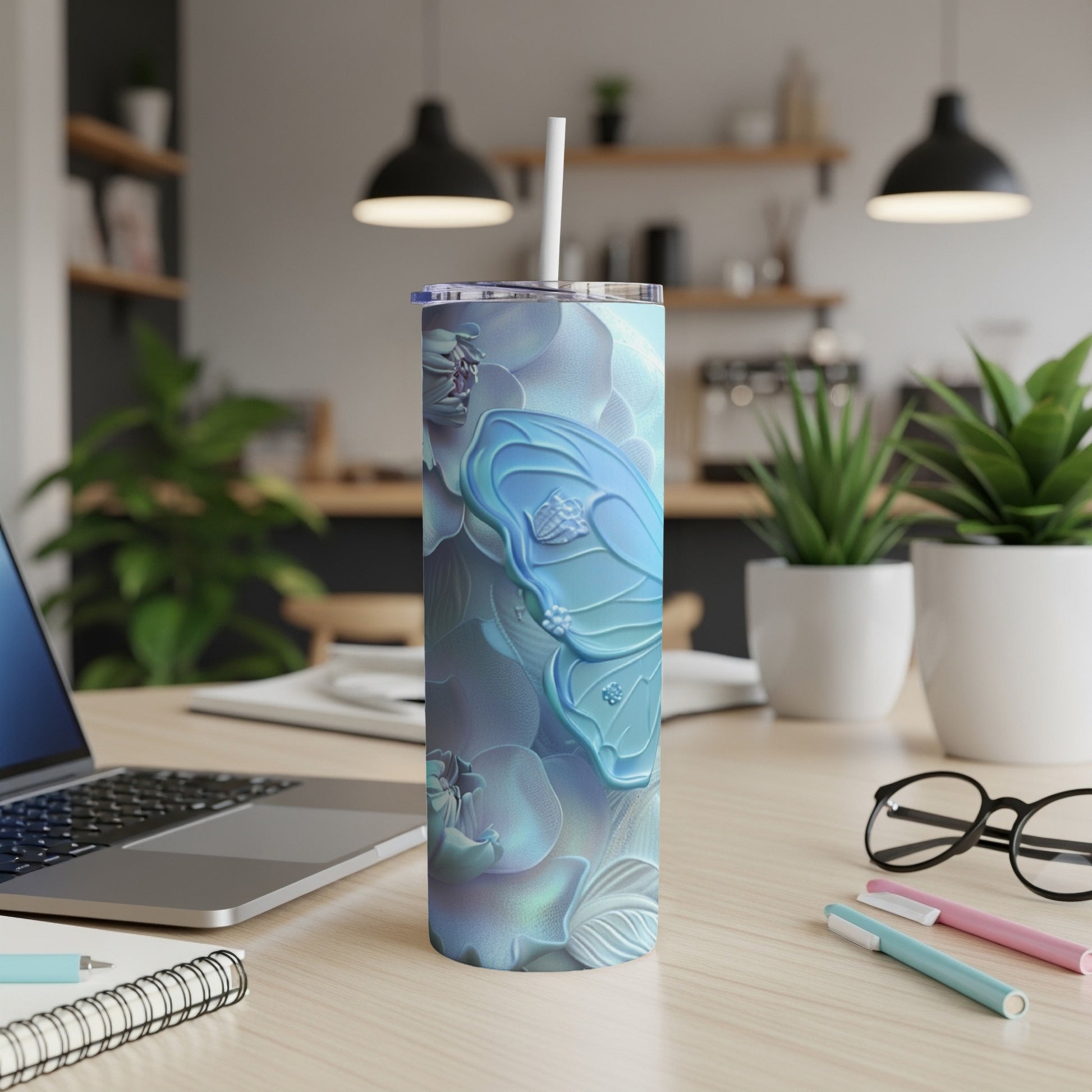 Blue butterfly design on a light blue, patterned tumbler with a straw.