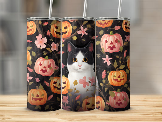 Black and white cat with pumpkins and flowers on a Halloween-themed tumbler.
