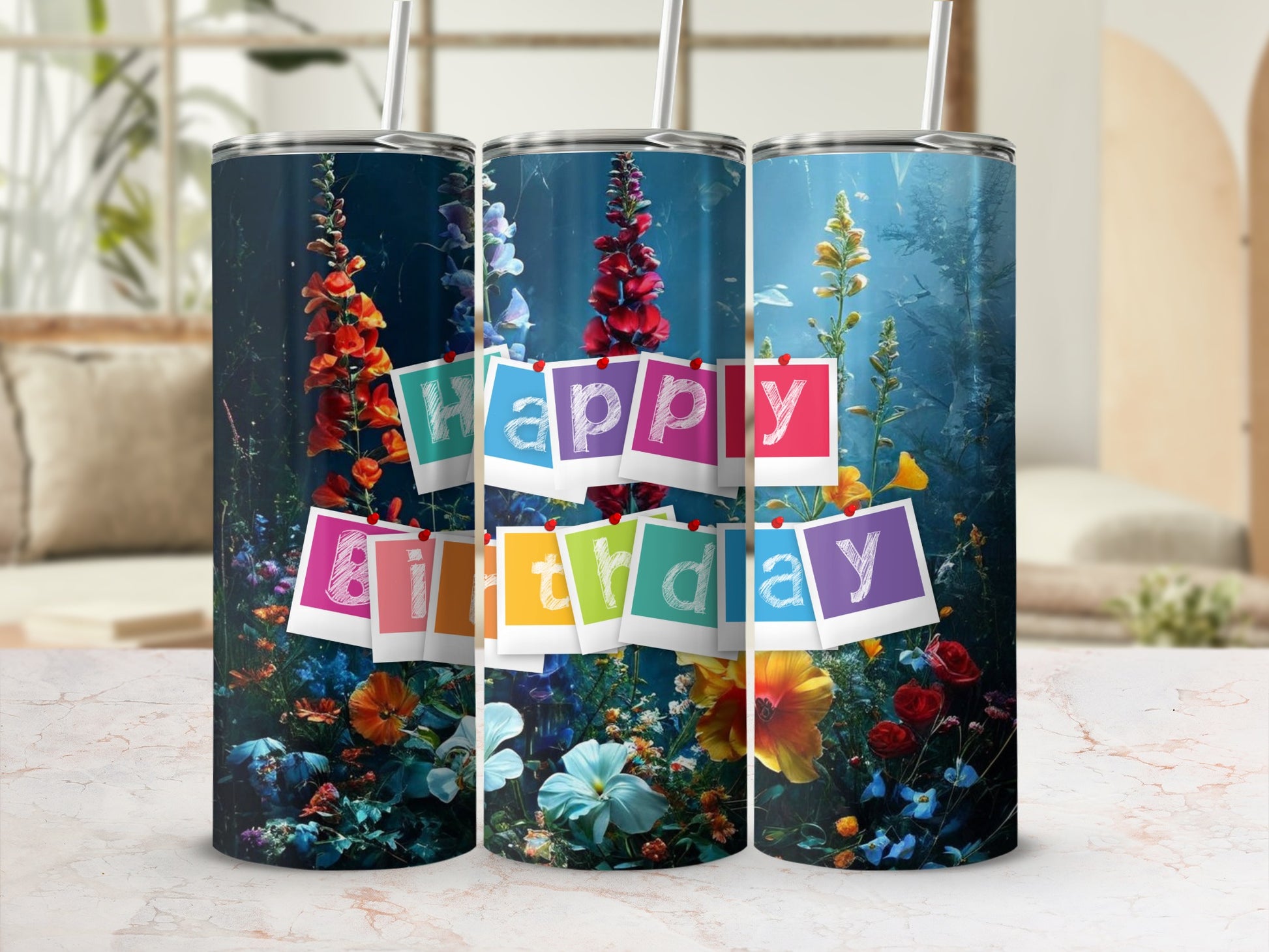 Three tumblers with "Happy Birthday" in colorful letters surrounded by flowers.