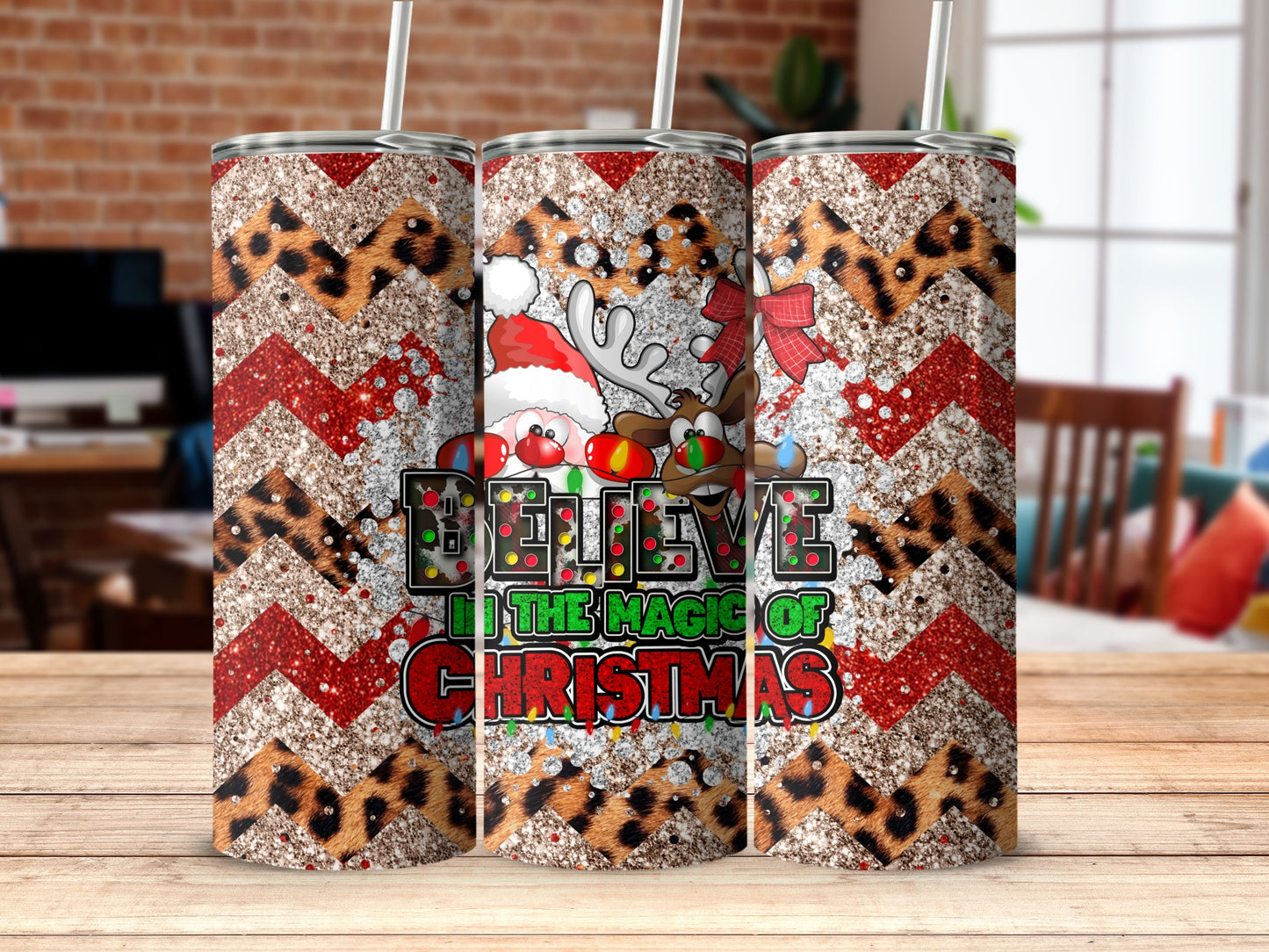 Trio of Christmas tumblers with Santa, reindeer, and festive patterns.