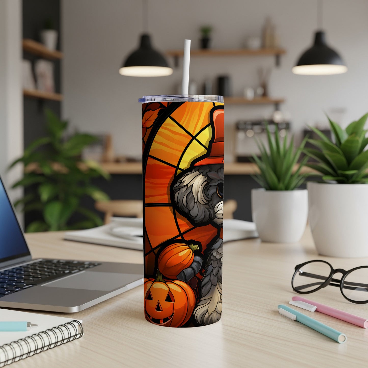 Halloween dog with pumpkins and autumn leaves on a tumbler with straw.