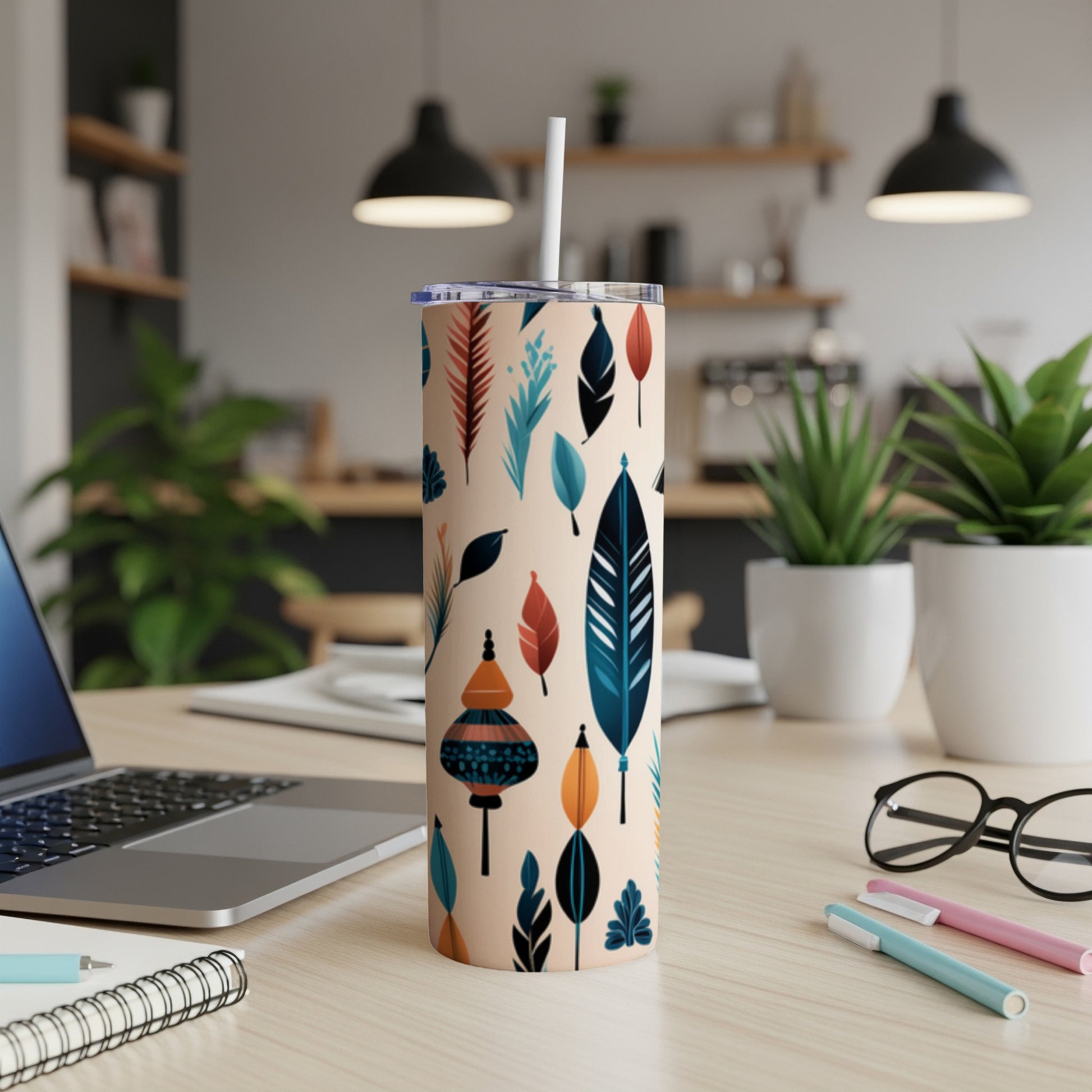 Beige tumbler with colorful feather and lantern pattern.