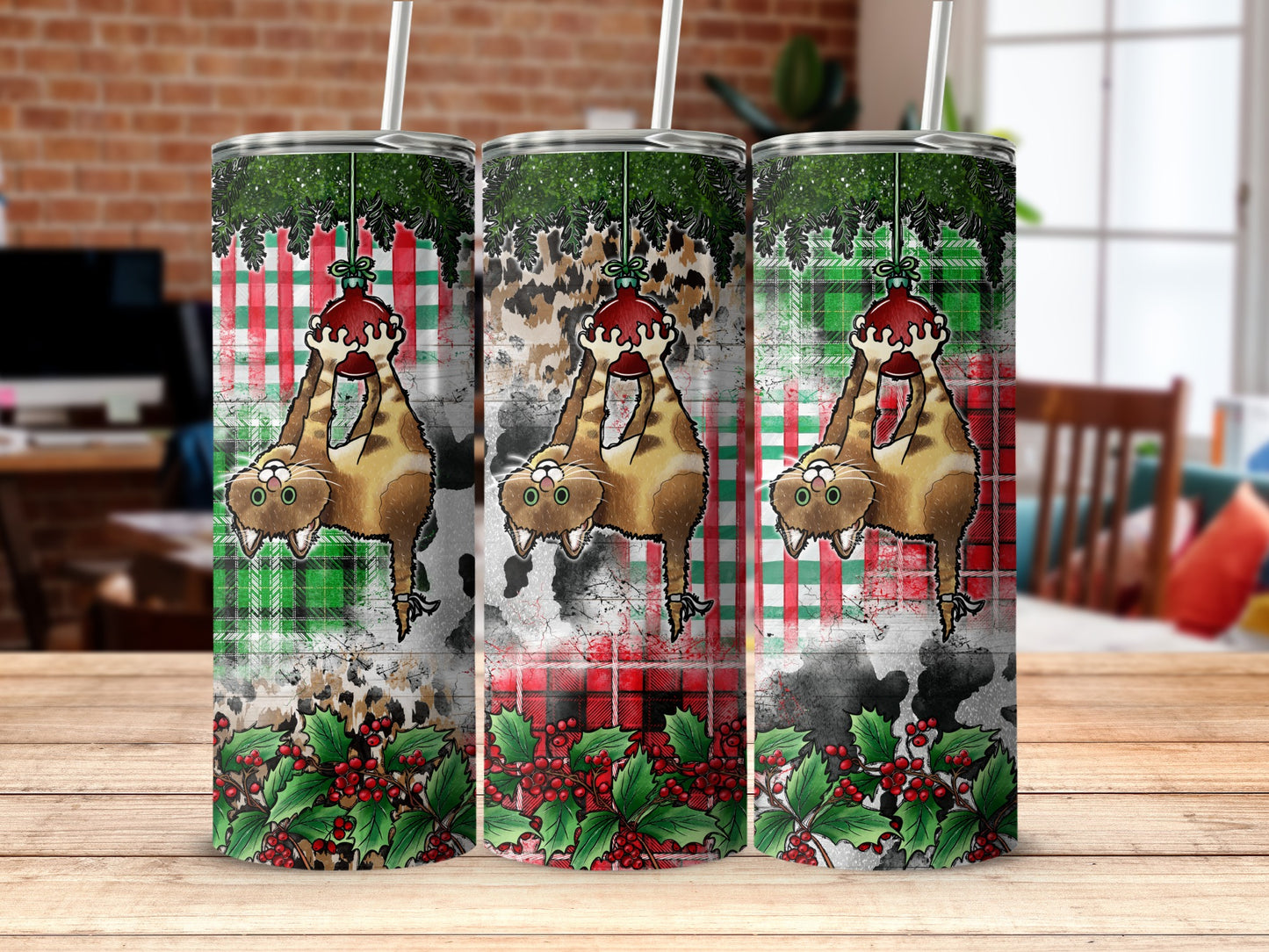 Three tumblers with hanging cat ornament, holly, and plaid patterns.