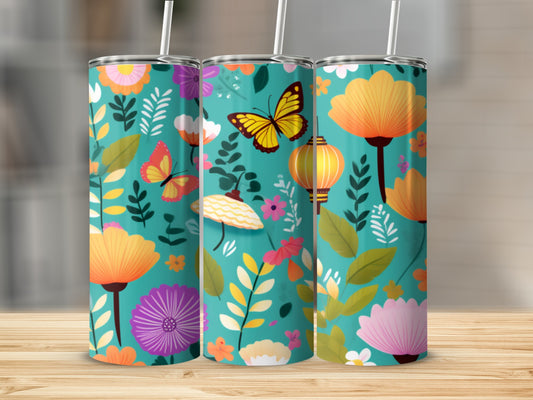 Turquoise tumbler with floral and butterfly pattern.