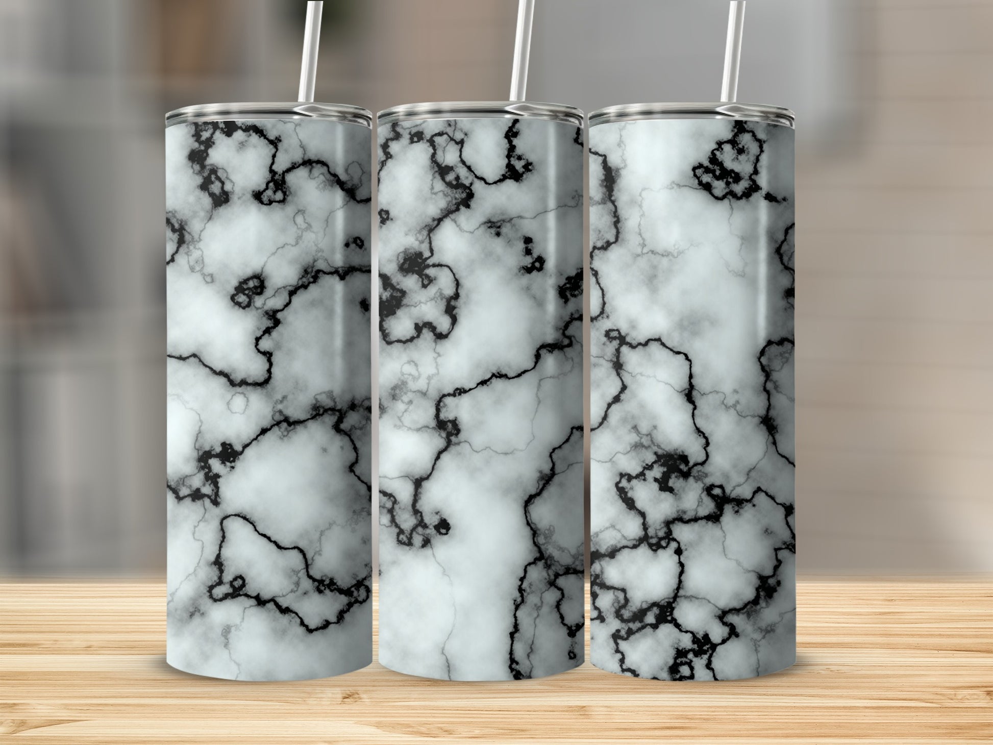 Three tumblers with a black and white marble pattern, each with a straw.