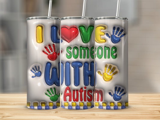 Tumbler with "I Love Someone With Autism" text and colorful handprints.