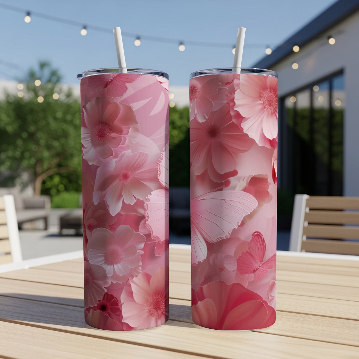 Pink floral pattern with butterflies on two tumblers with straws.