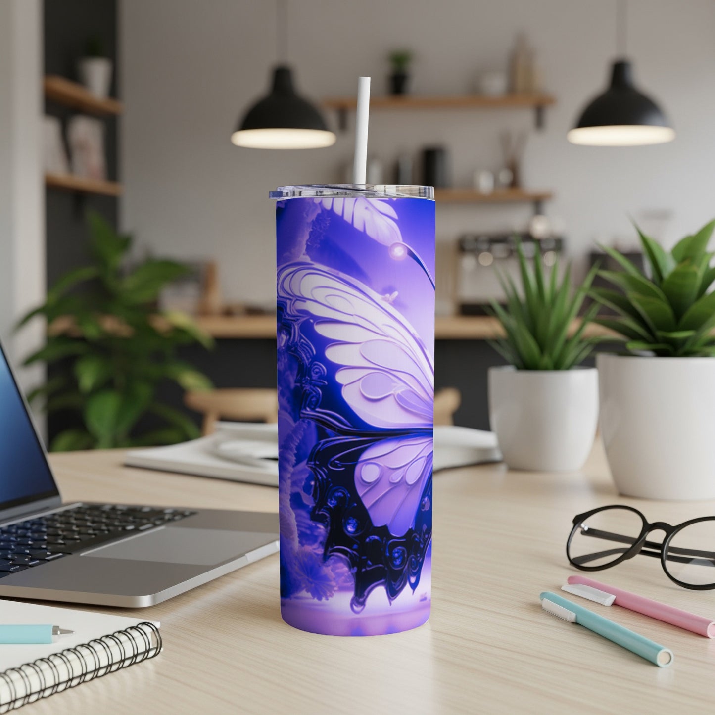 Purple tumbler with butterfly design on a desk.