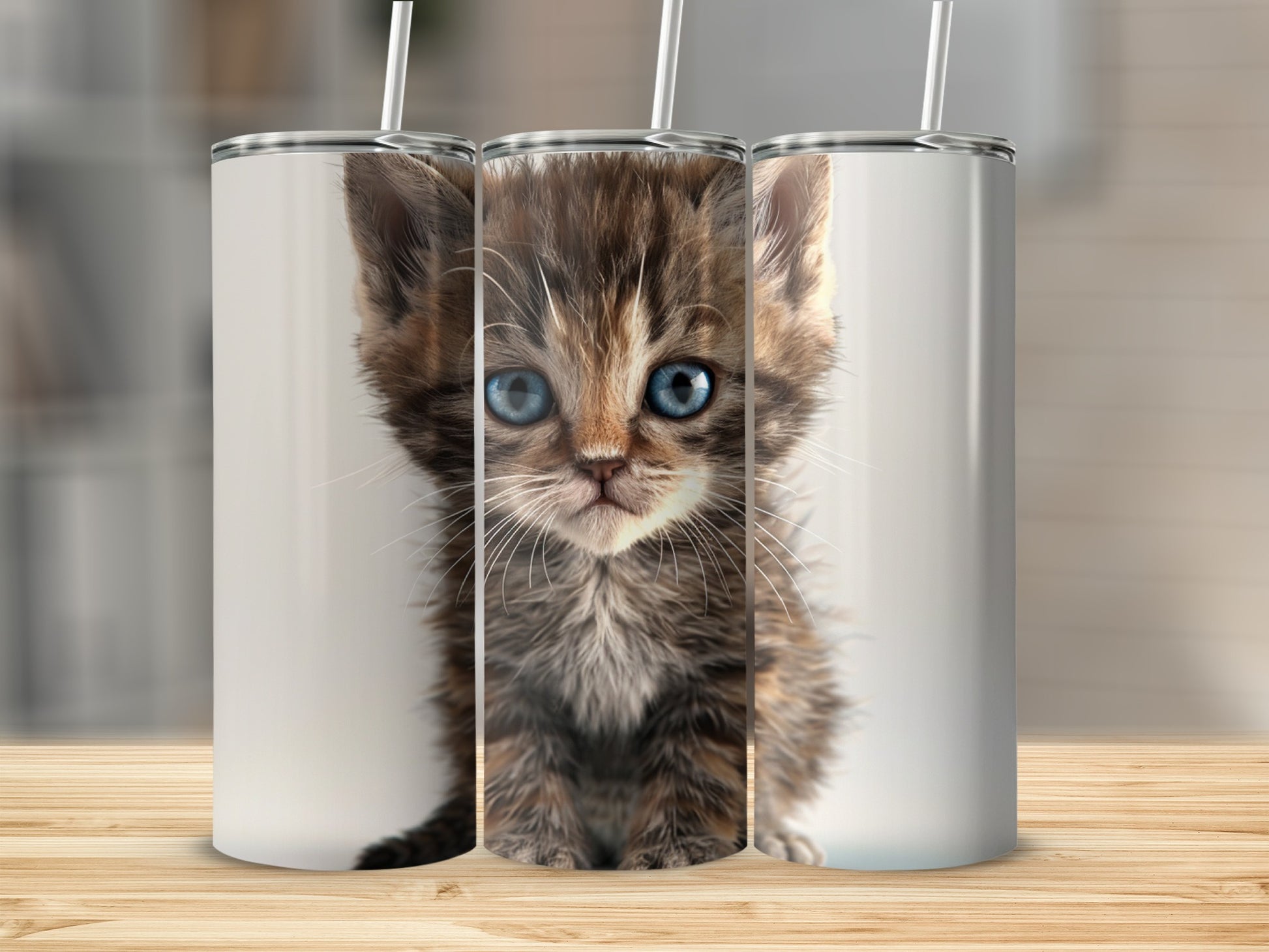 Three stainless steel tumblers featuring a close-up of a fluffy kitten's face.