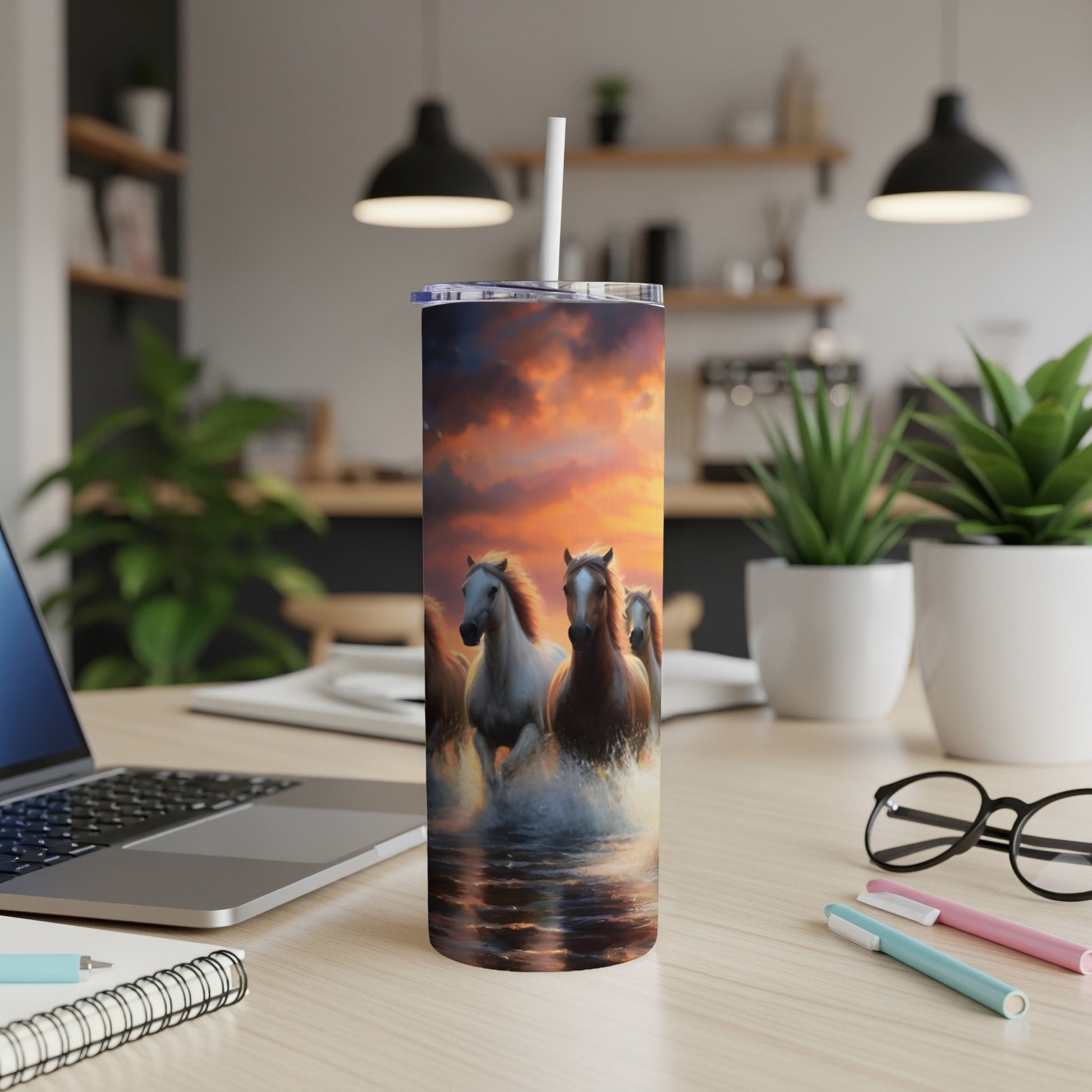 Wild horses running through water at sunset, depicted on a tumbler.