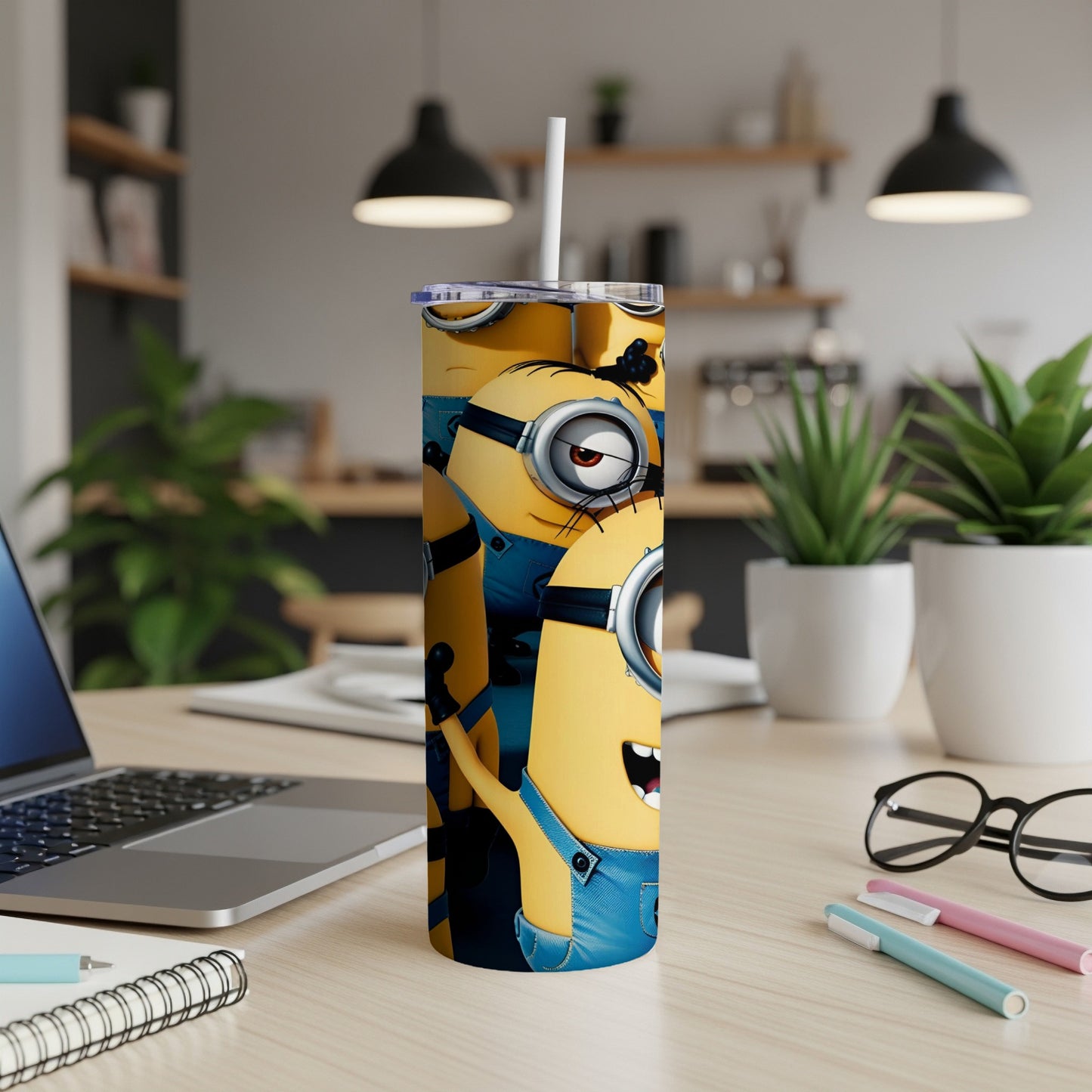 Minion characters on a tall, blue tumbler with a straw.