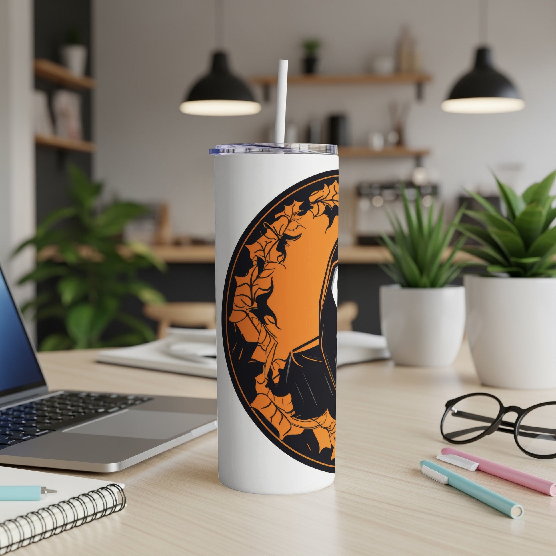 White tumbler with a black and orange leaf design featuring a bat silhouette.