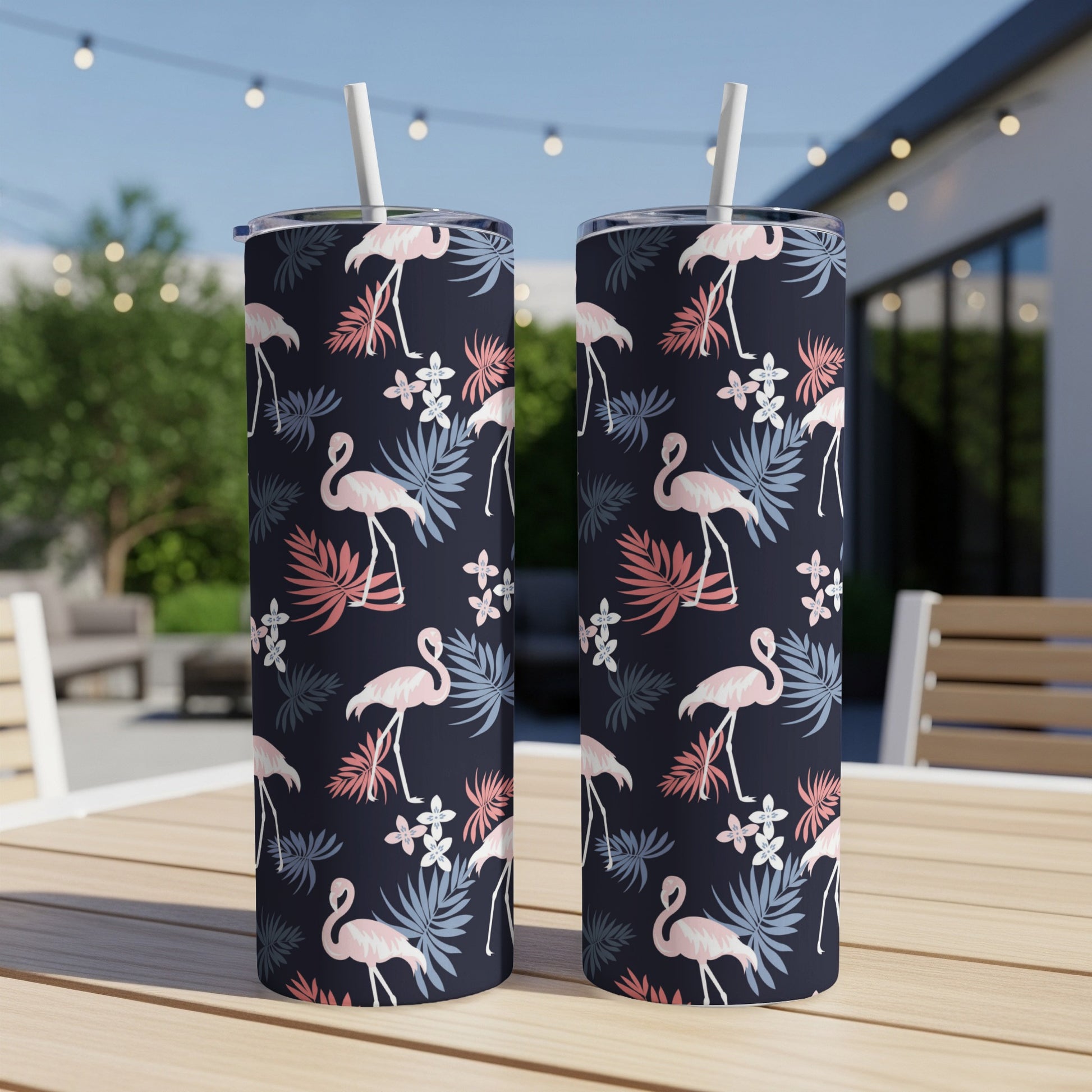 Two navy tumblers with a flamingo and floral pattern.