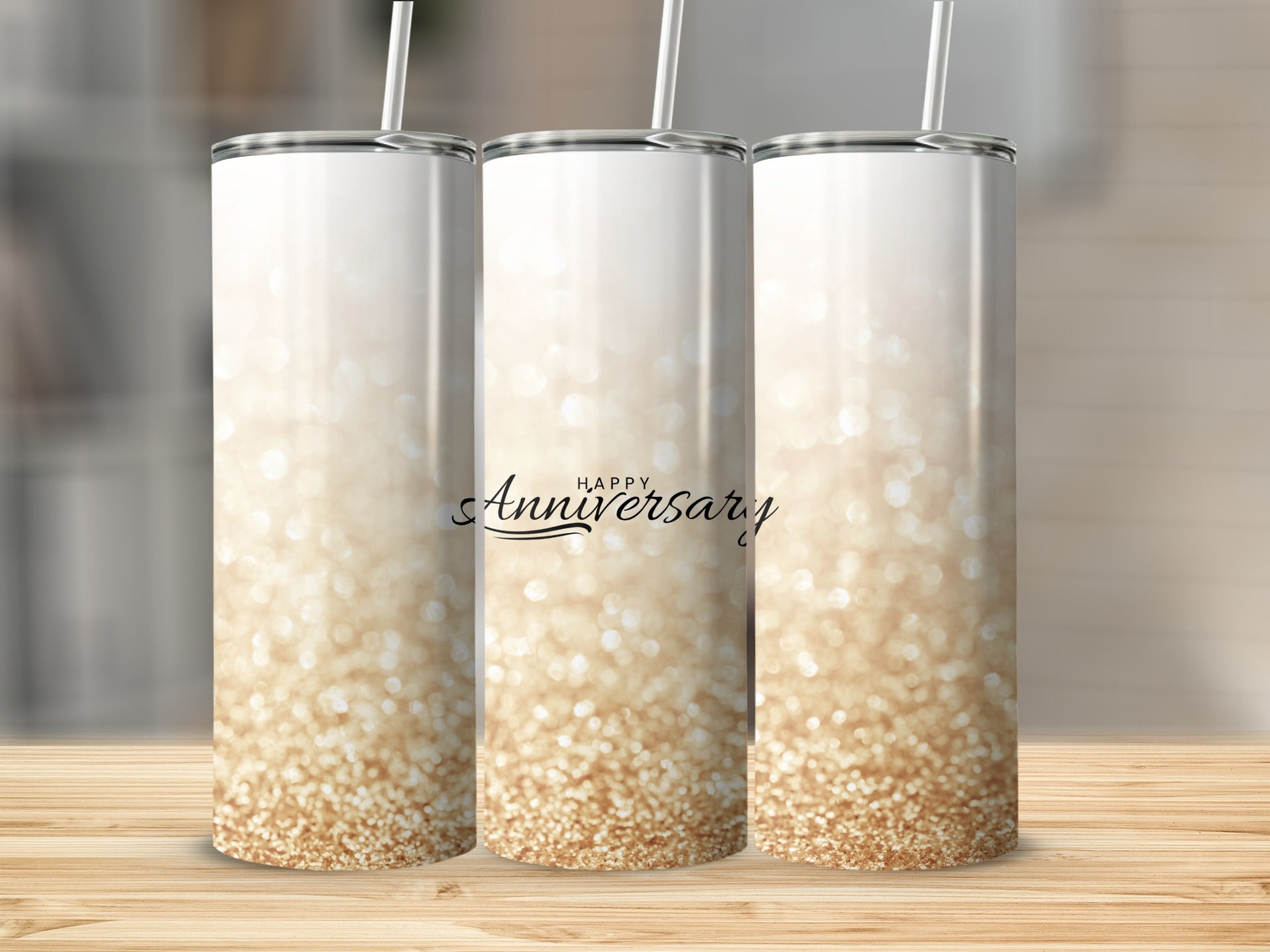 Three glitter-covered tumblers with "Happy Anniversary" text.