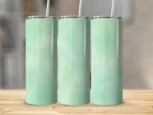 Three mint green tumblers with white straws on a wooden surface.