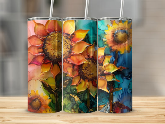 Three tumblers featuring vibrant sunflower designs on a wooden surface.