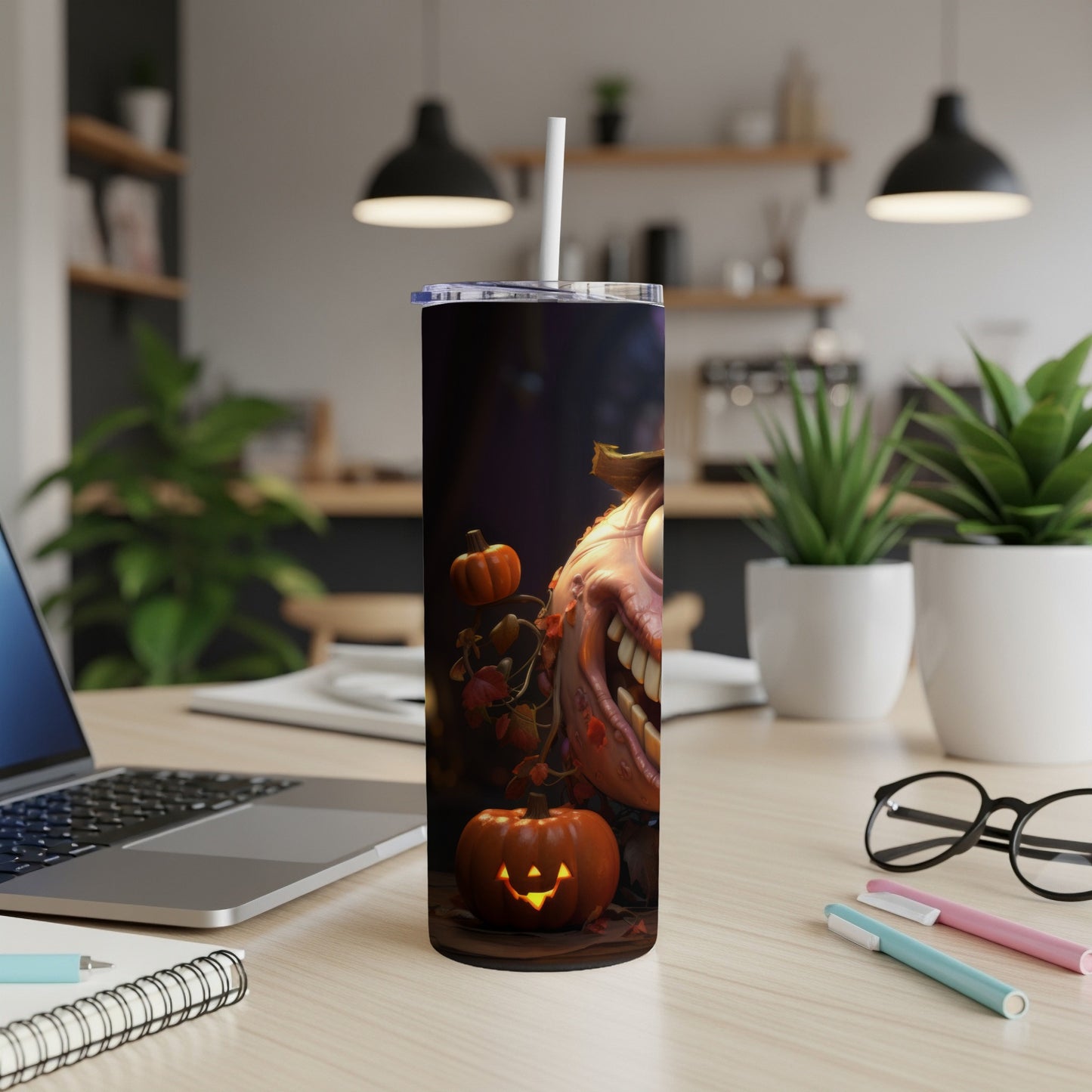 Tumbler with a spooky pumpkin face and falling leaves Halloween design.