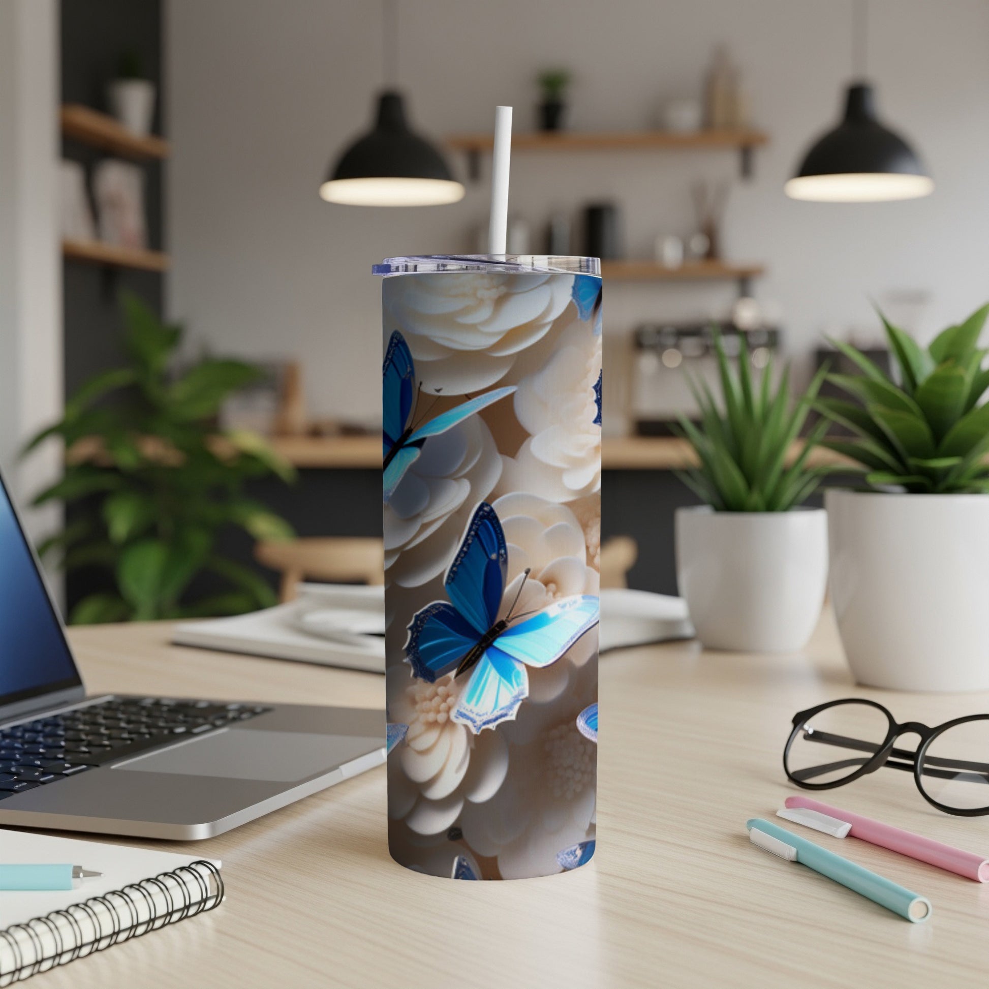 White tumbler with blue butterflies and floral pattern.