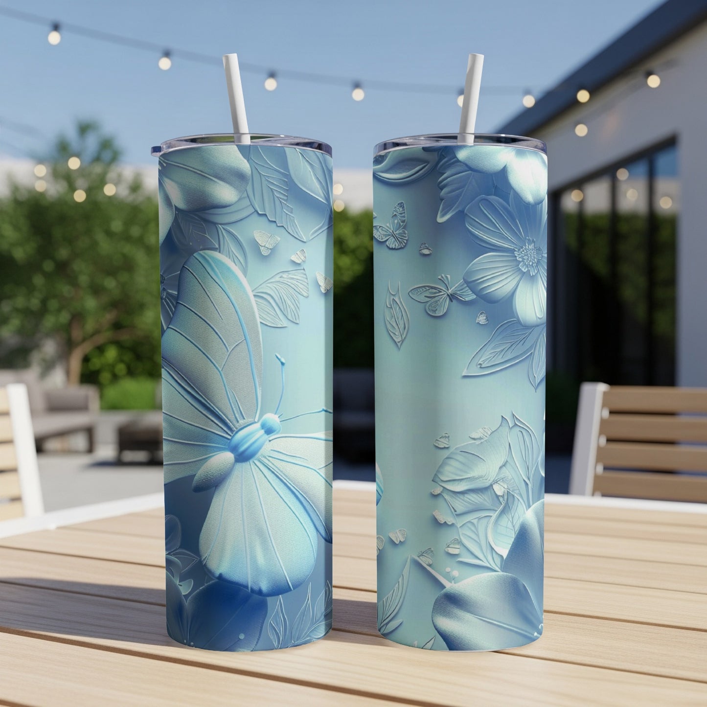 Two light blue tumblers with embossed butterflies and floral designs.