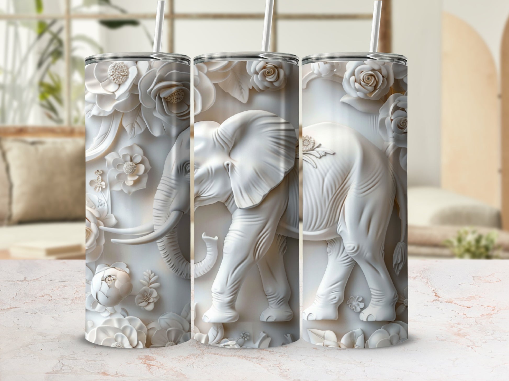 White embossed elephant and floral design on a tumbler.