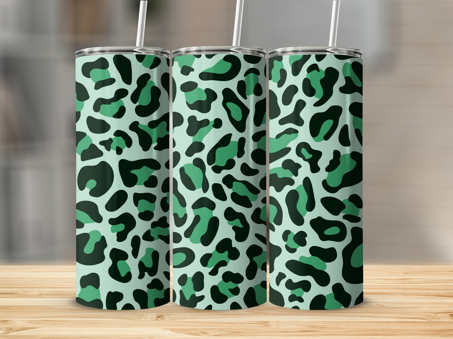 Three tall tumblers with a mint green and dark green leopard print pattern.