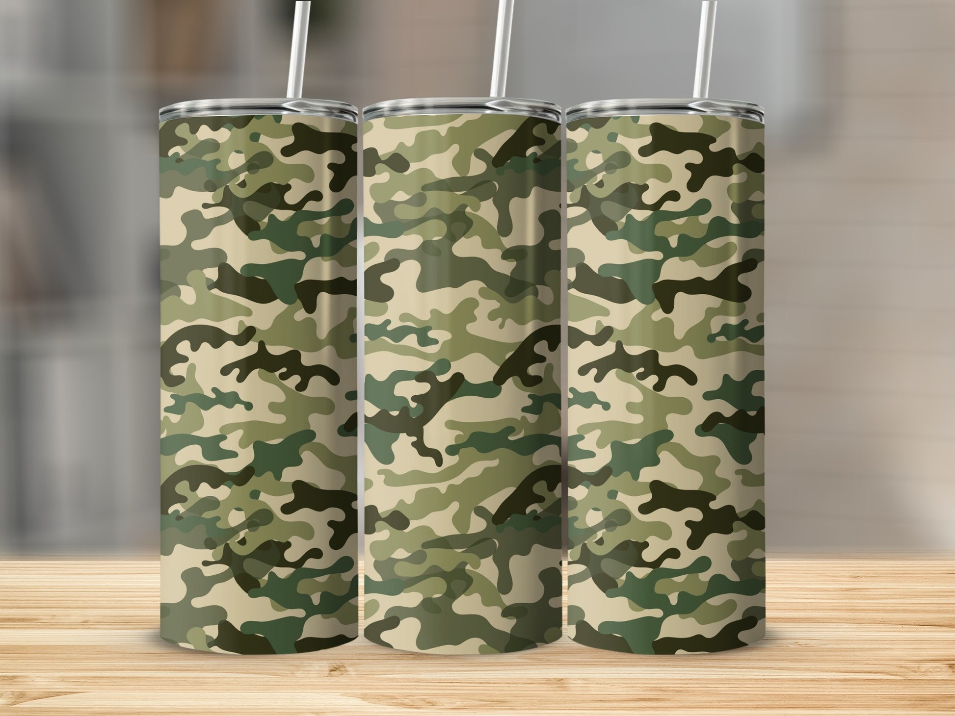 Three tumblers with camouflage pattern stand on a wooden surface.