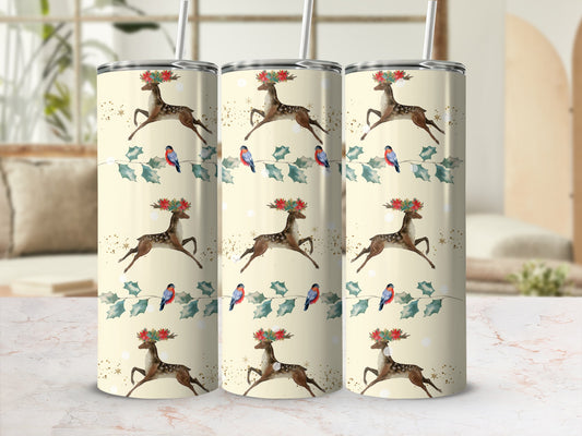 Three tumblers with a repeating pattern of reindeer, birds, and holly on a pale yellow background.
