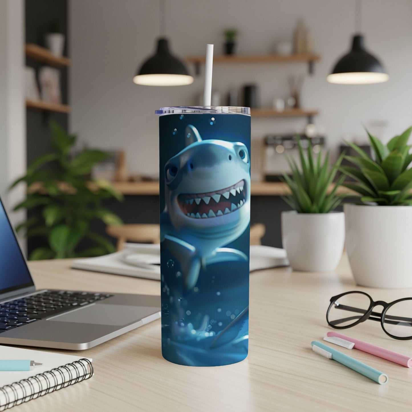 Cartoon shark design on a white insulated tumbler with straw.