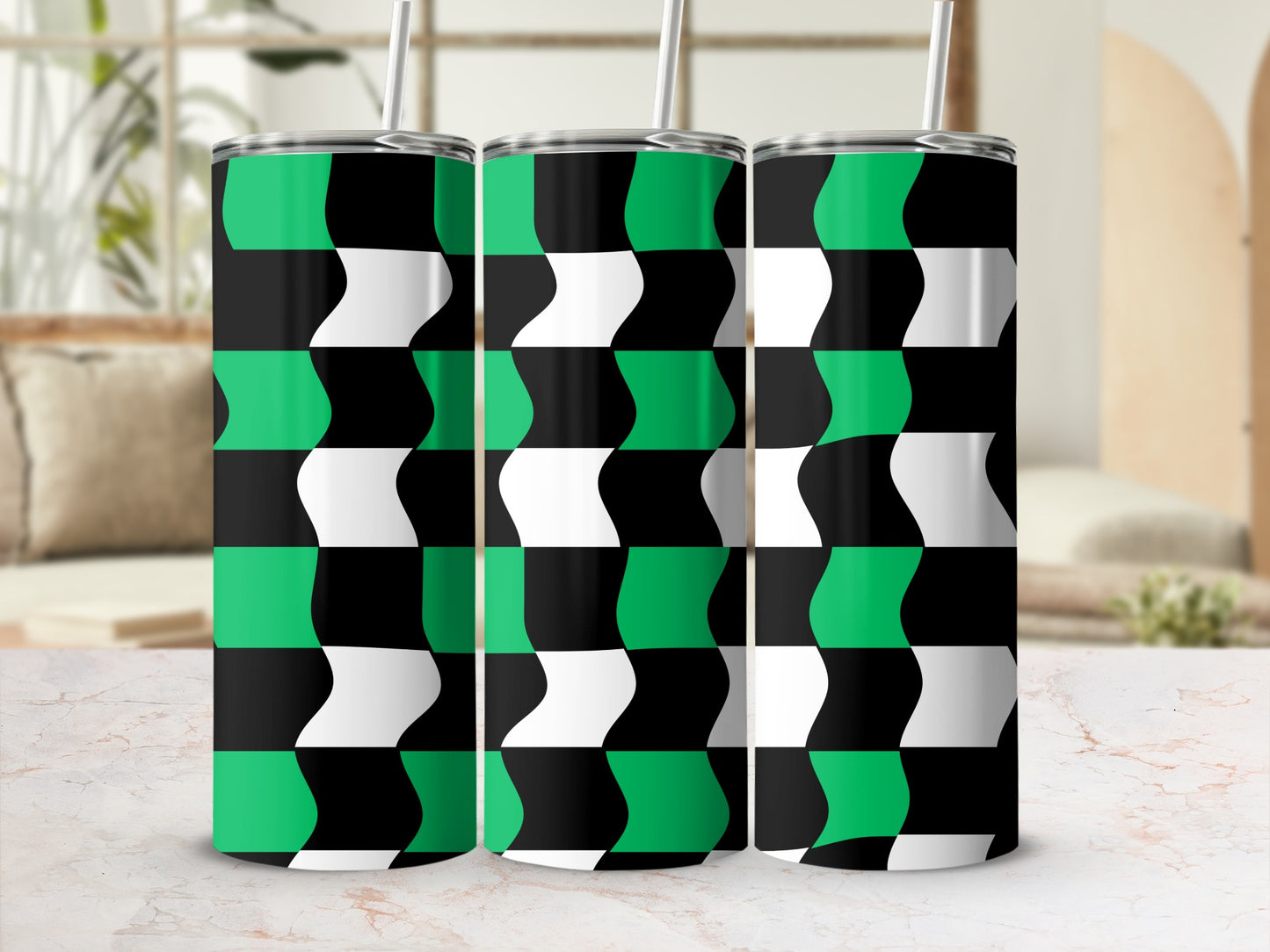 Three green, black, and white checkered pattern tumblers with straws.