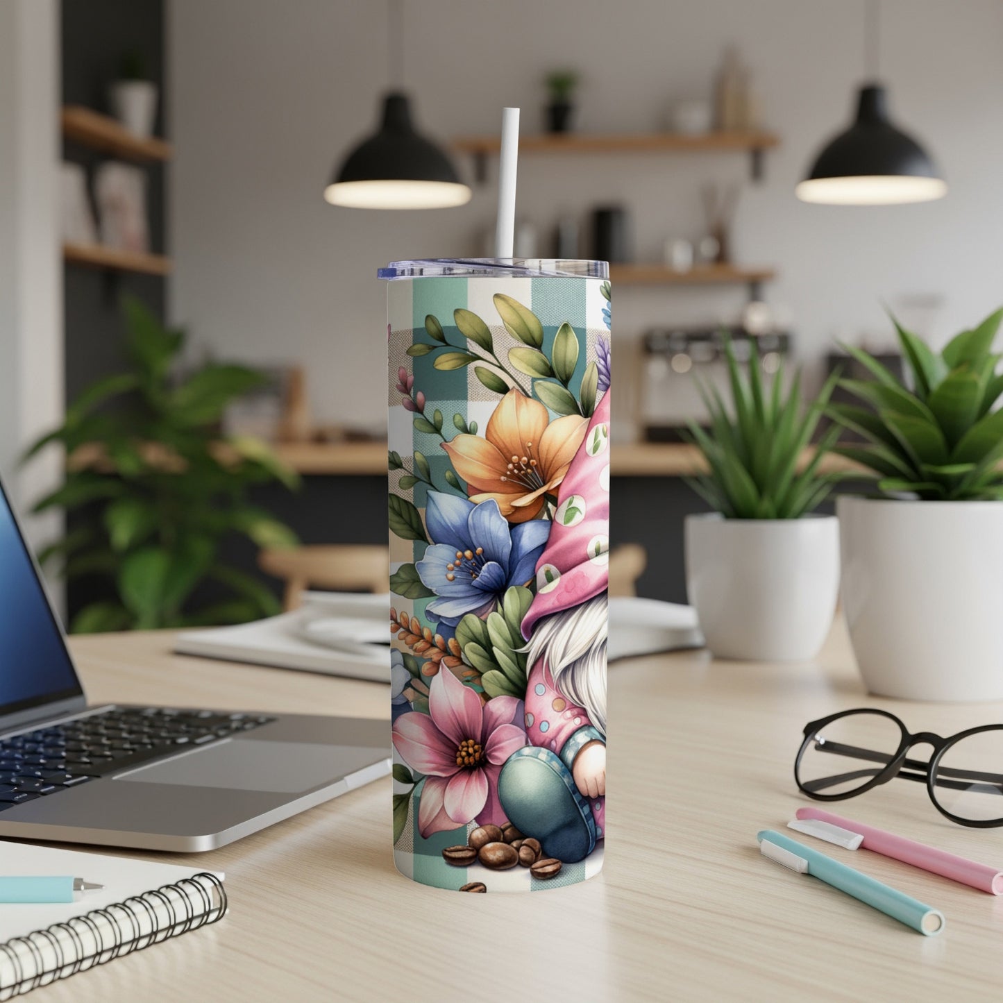 Gnome and floral design on a plaid tumbler with a straw.