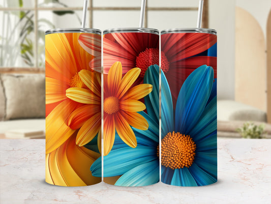 Three tumblers with colorful floral designs, one orange, one red, one blue.