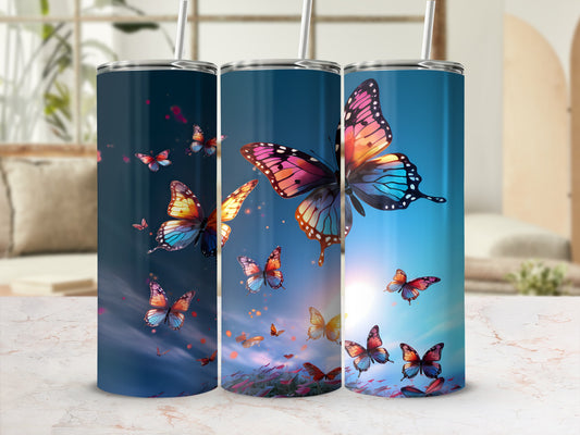 Three tumblers with colorful butterflies and a sunset background.