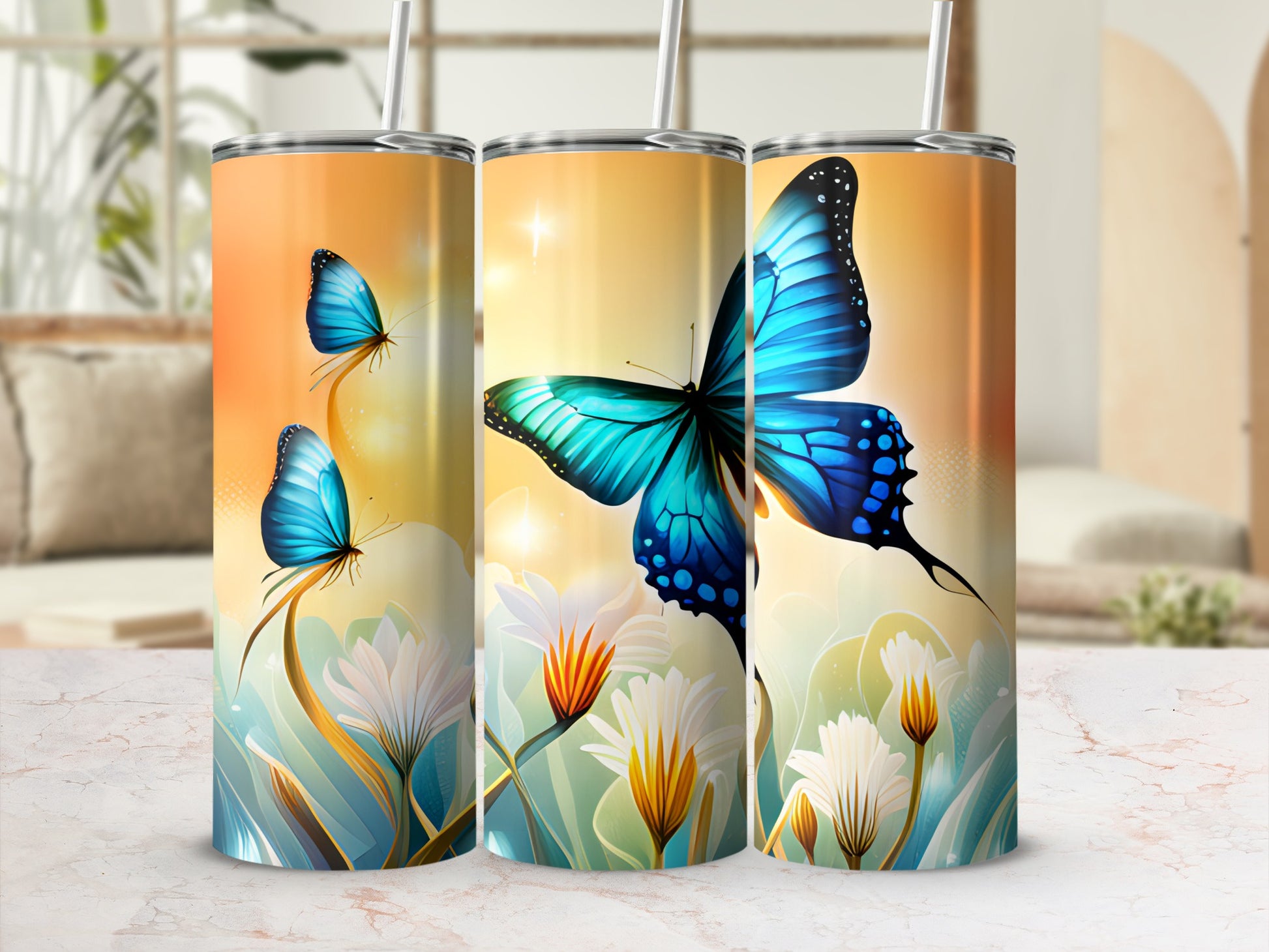Three tumblers featuring blue butterflies on floral stems against a golden bokeh background.