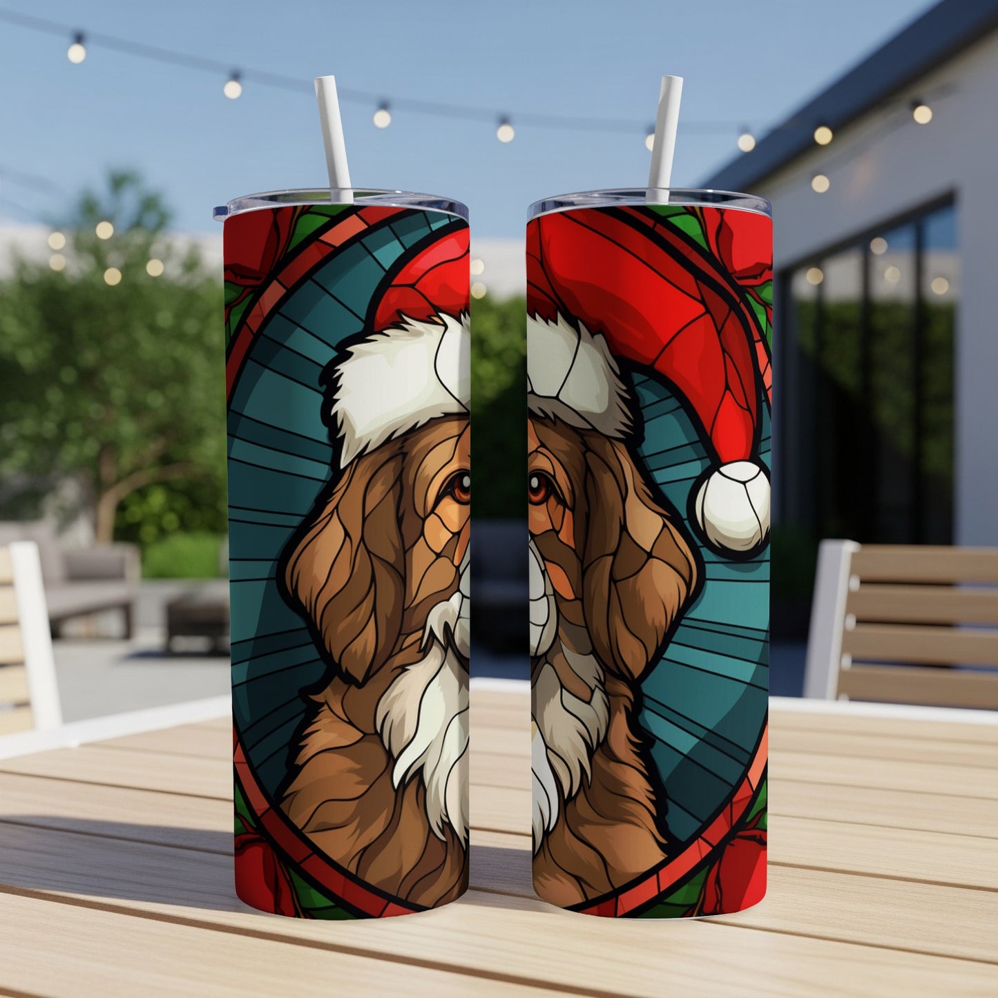 Two tumblers featuring a stained-glass dog wearing a Santa hat.