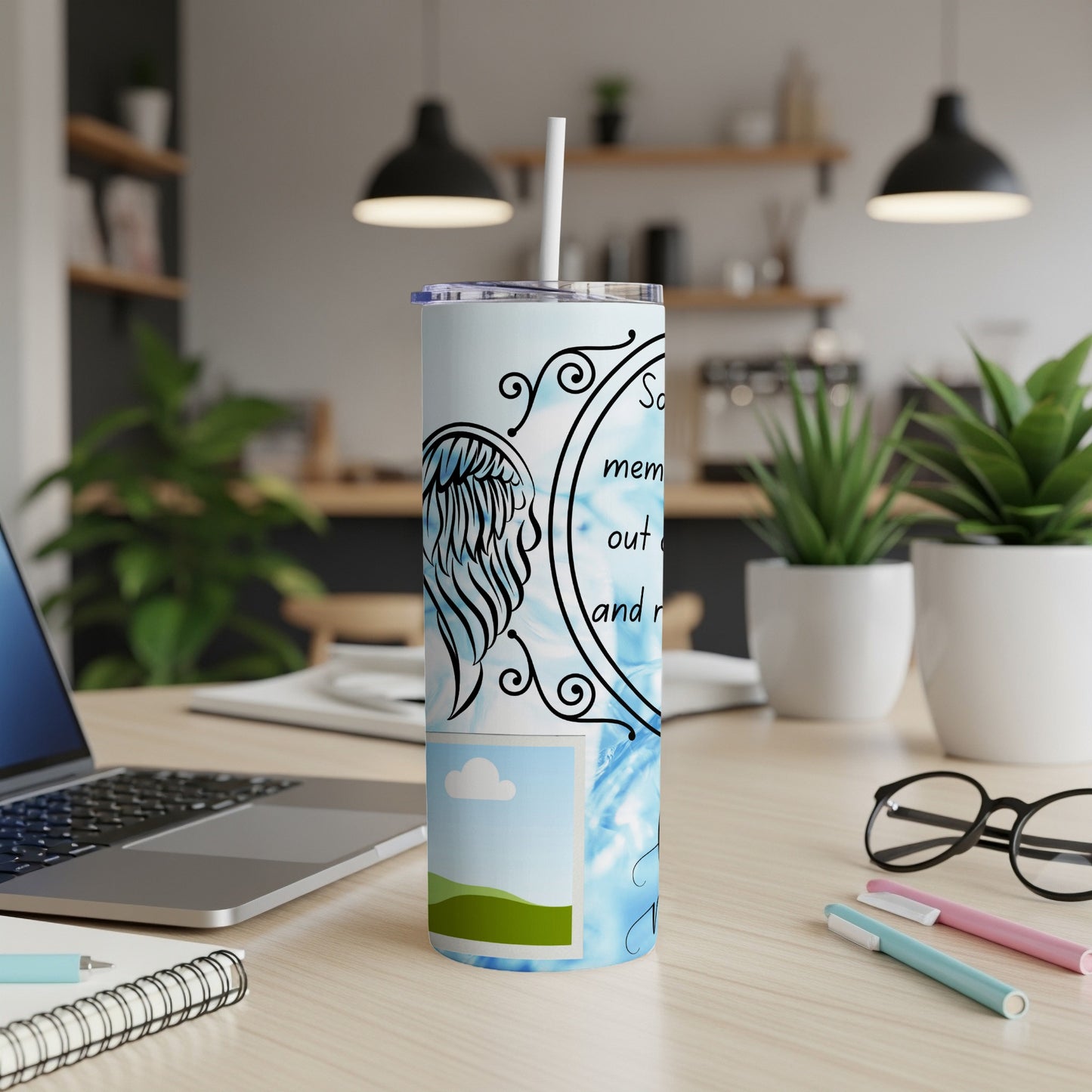 Tumbler with angel wings, a photo frame, and text on a blue background.