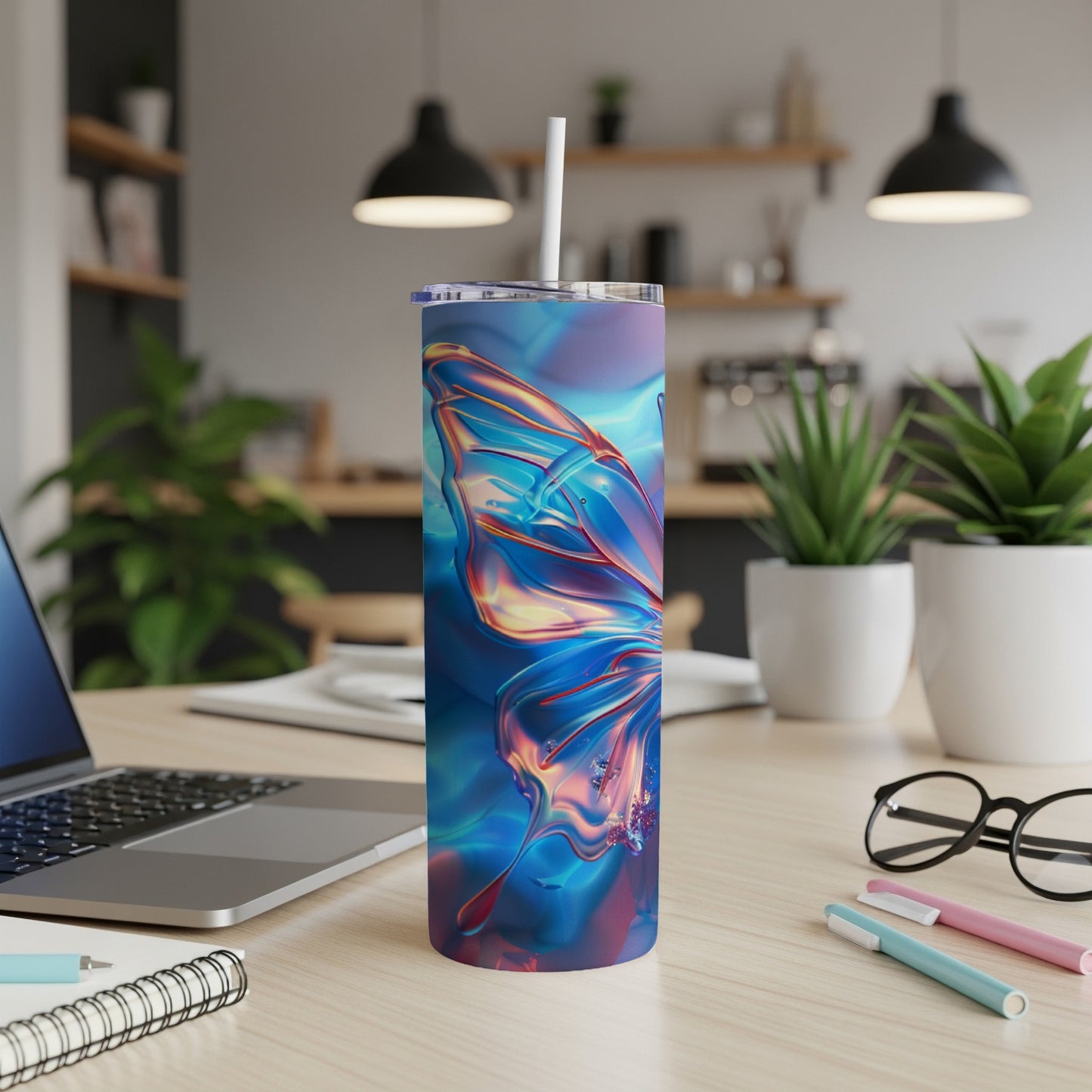Iridescent butterfly tumbler with straw on a desk.