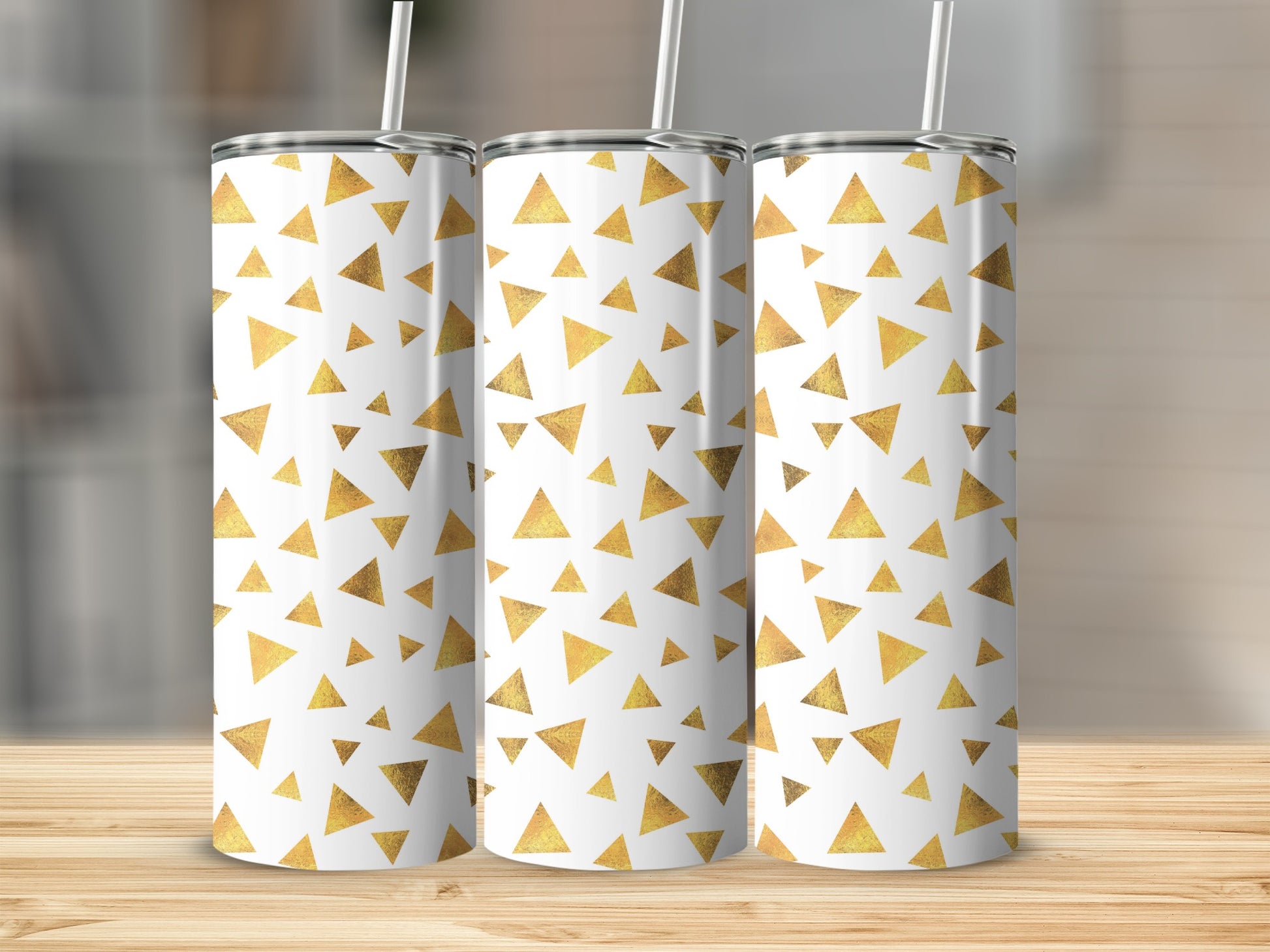 Three tumblers with a white background and scattered gold triangle pattern.