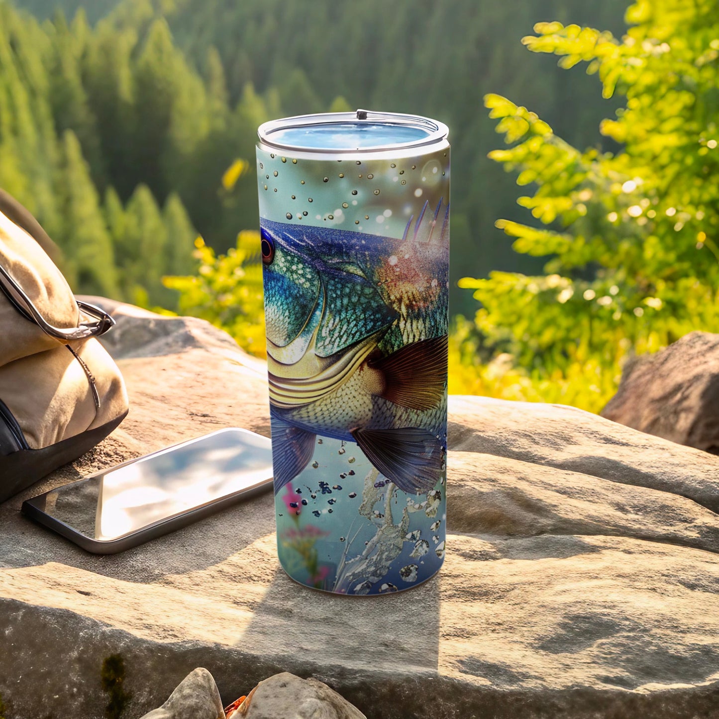 Fish graphic on a stainless steel tumbler with outdoor background.