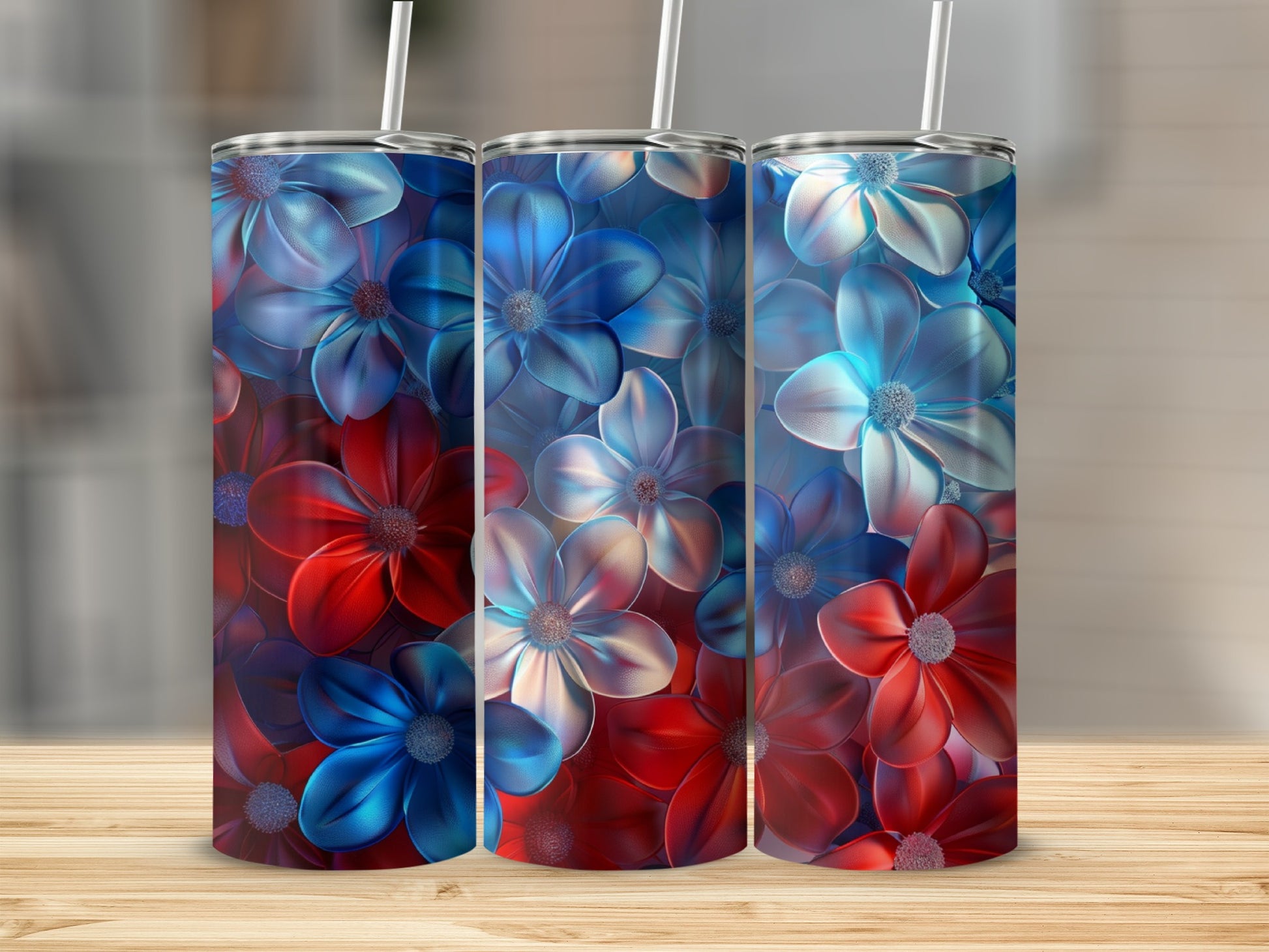 Red, white, and blue floral pattern on three tumblers with straws.