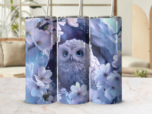 White owl with blue eyes surrounded by white flowers and blue leaves.