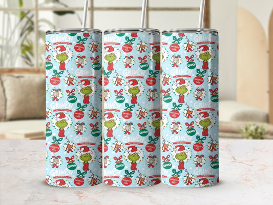 Grinch holiday pattern on three tumblers with straws.
