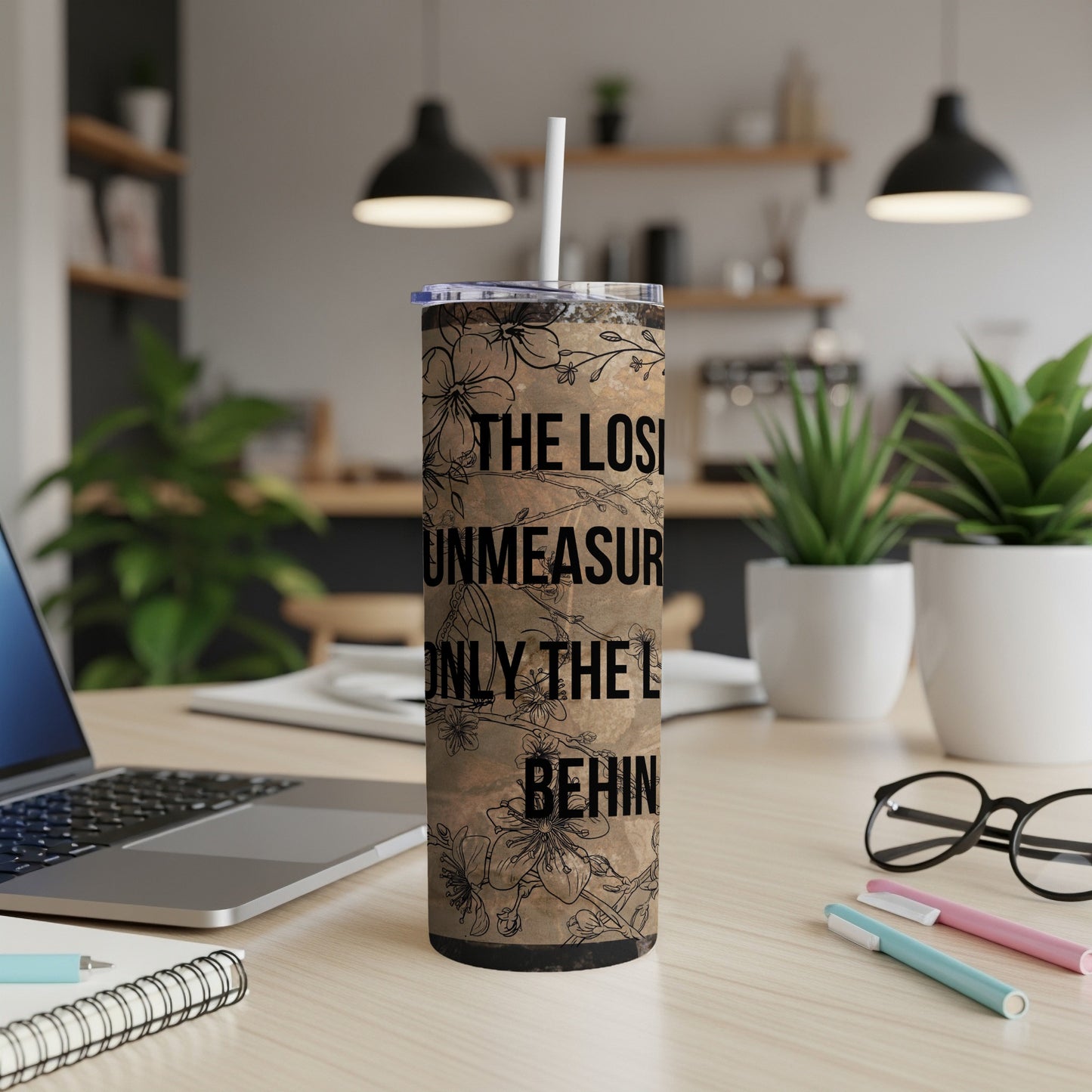 Floral tumbler with text: "The losing unmeasured only the l behind."