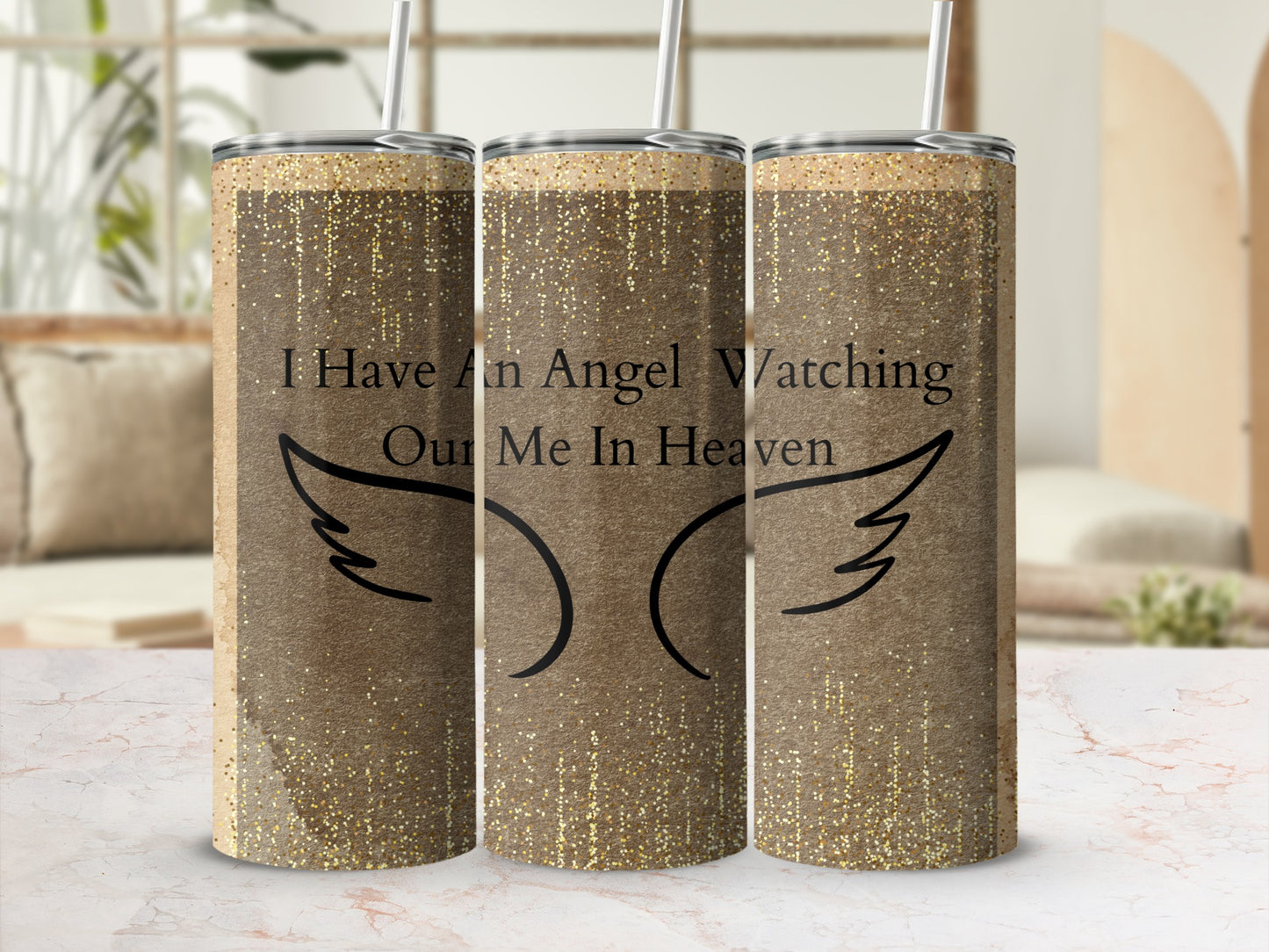 Gold glitter tumbler with wings and "I Have An Angel Watching Our Me In Heaven" text.