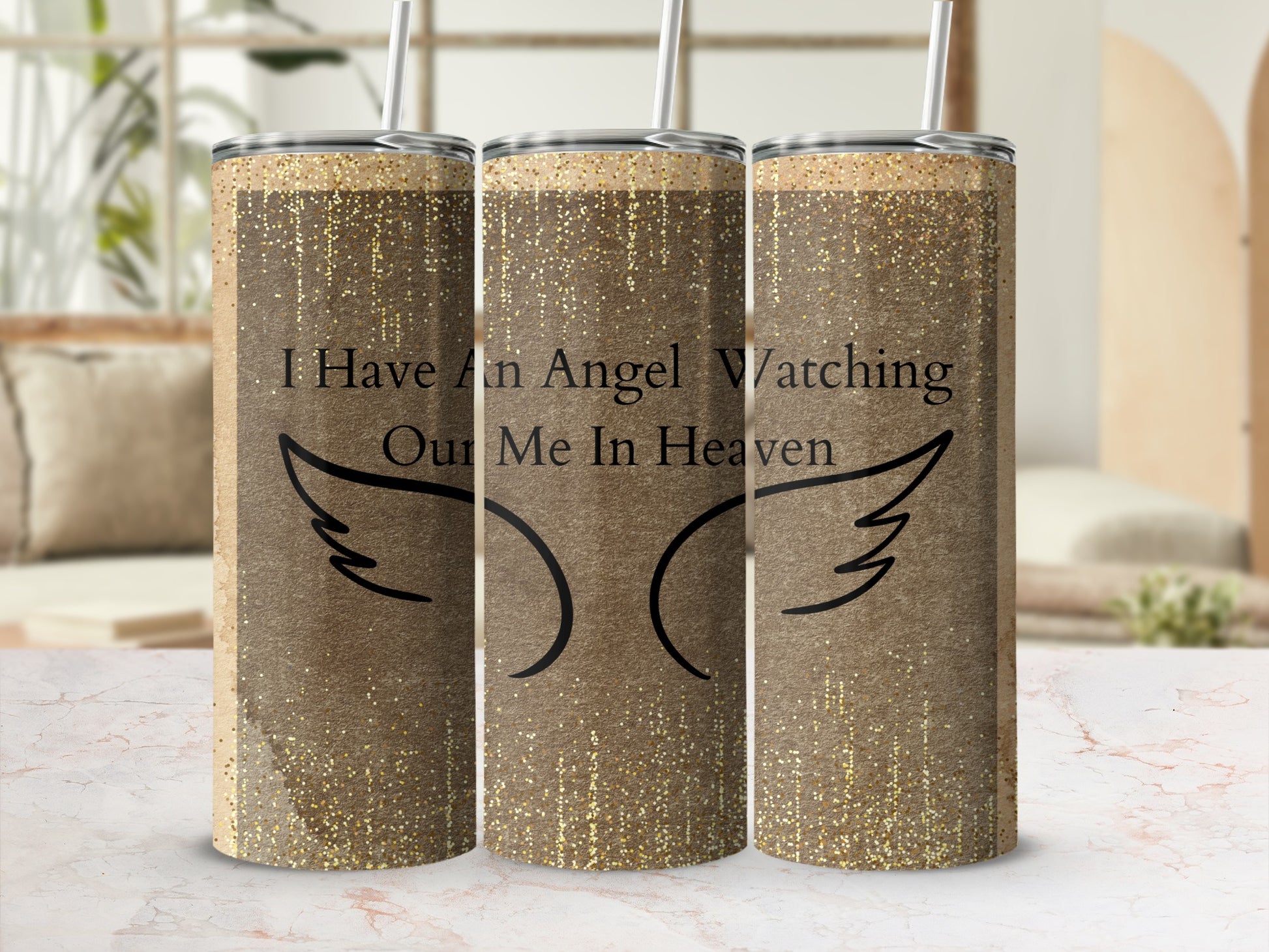 Gold glitter tumbler with wings and "I Have An Angel Watching Our Me In Heaven" text.